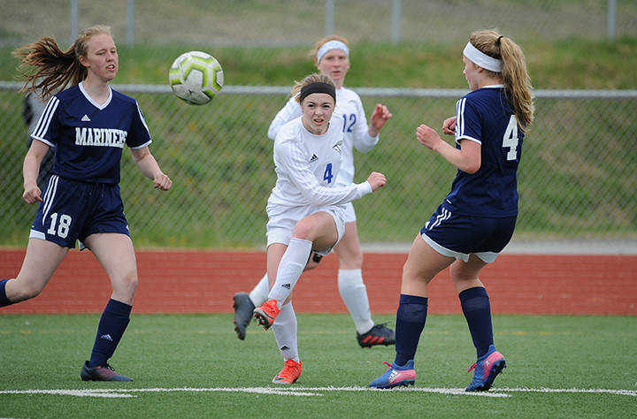 Thunder Mountain’s Elizabeth Knapp drives the ball between Homer defenders during the ASAA/First National Bank Alaska soccer state championships at Eagle River High School on Thursday, May 23, 2019. TMHS won 1-0. (Michael Dinneen | For the Juneau Empire)