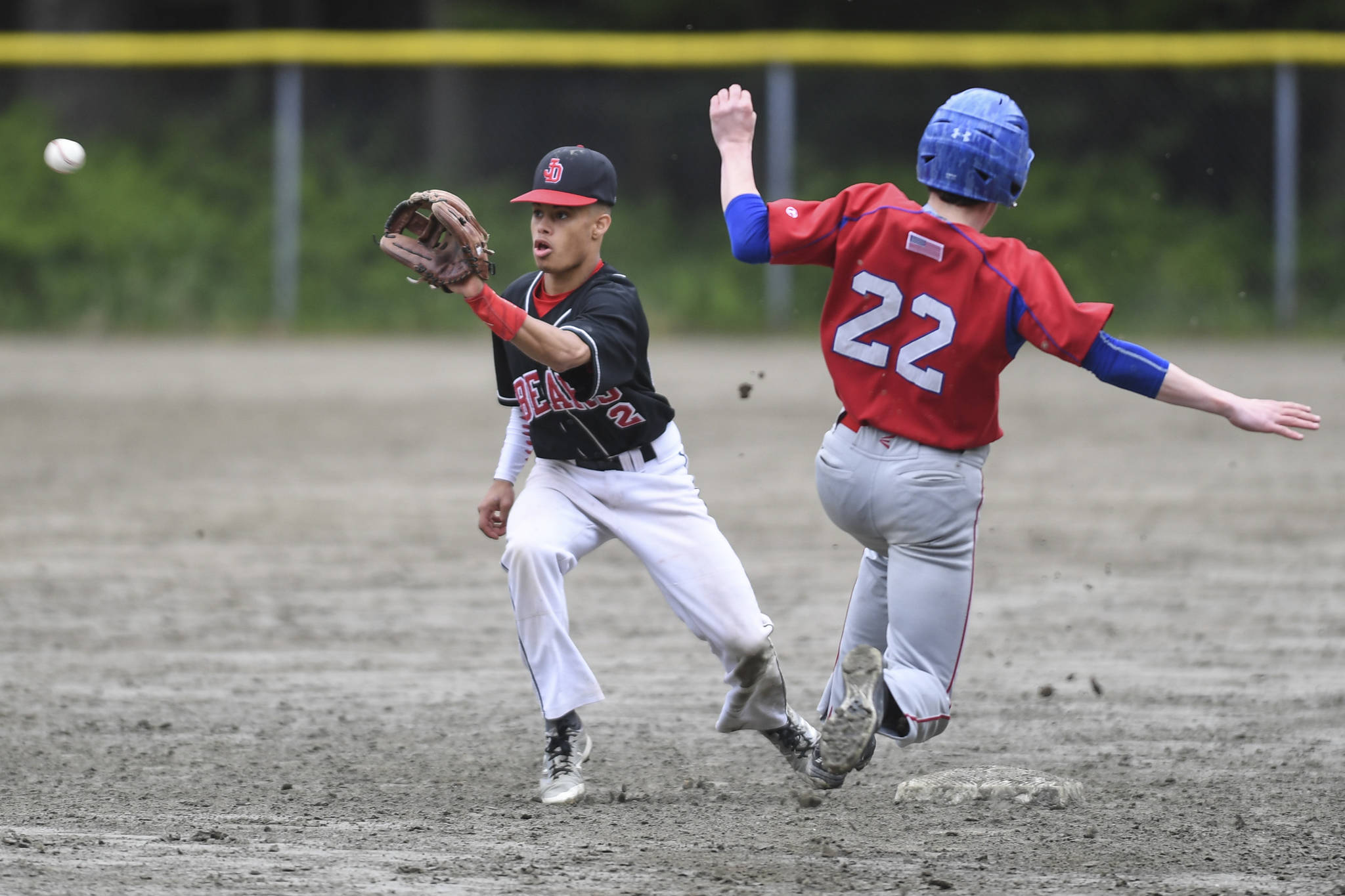 Sitka’s Michael Leach, right, beats the throw to Juneau-Douglas’ Gaby Soto to steal second base during the Region V Baseball Championship at Adair-Kennedy Memorial Park on Thursday, May 23, 2019. JDHS won 6-5. (Michael Penn | Juneau Empire)