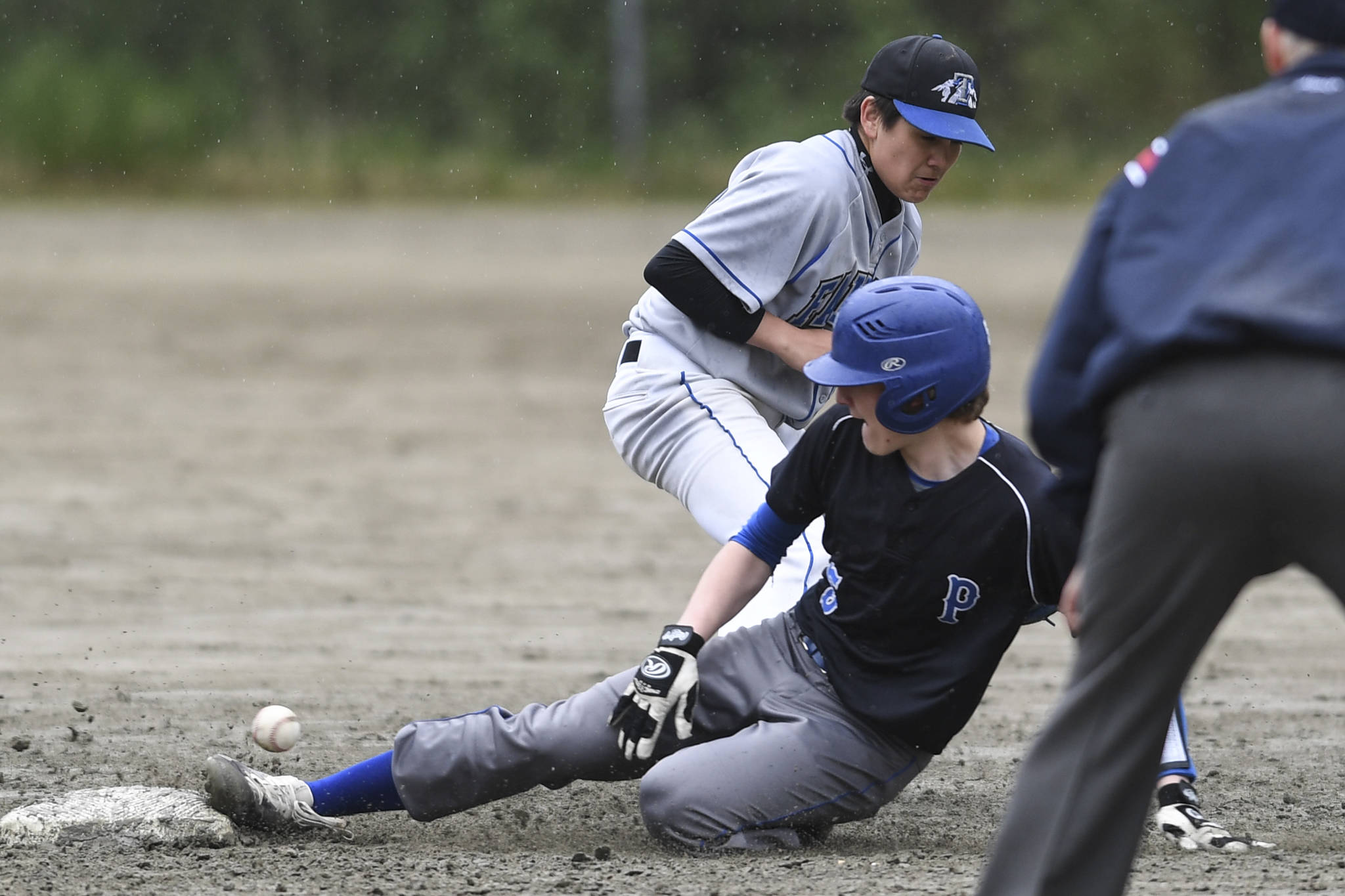Petersburg’s Thomas Durkin slides safely into second base in the sixth inning as the ball gets away from Thunder Mountain’s Oliver Mendoza during the Region V Baseball Championship at Adair-Kennedy Memorial Park on Thursday, May 23, 2019. Petersburg won 4-1. (Michael Penn | Juneau Empire)