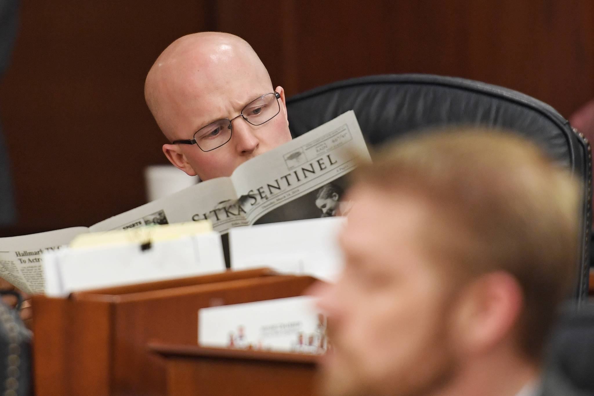 Rep. Jonathan Kreiss-Tomkins, D-Sitka, catches up on his hometown news as the House works on last minute bills on Wednesday, May 15, 2019. (Michael Penn | Juneau Empire)