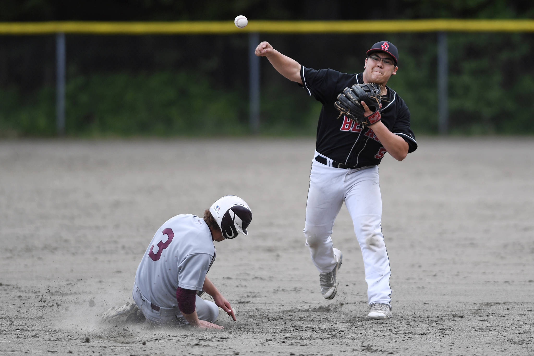 Juneau-Douglas’ Kona Ogoy, right, forces Ketchikan’s Brock King out at second as he completes the double play to first during the Region V Baseball Championship at Adair-Kennedy Memorial Park on Friday, May 24, 2019. (Michael Penn | Juneau Empire)