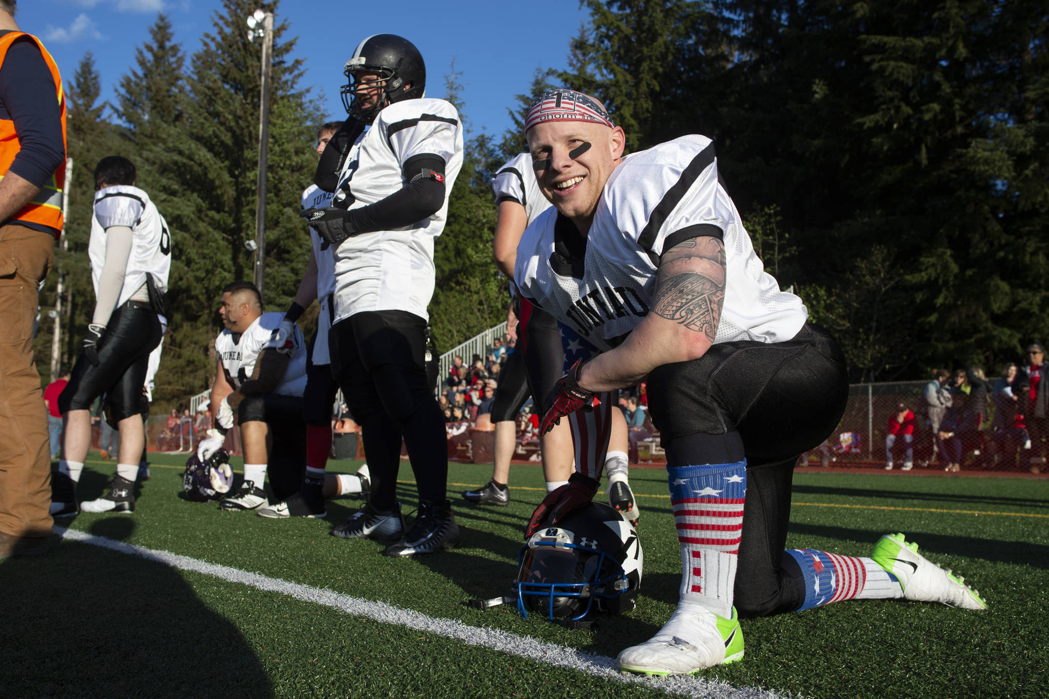 Stars’ player Mike Wright kneels during the Juneau Alumni Football Game at Adair-Kennedy Memorial Field on Friday, May 24, 2019. (Michael Penn | Juneau Empire)