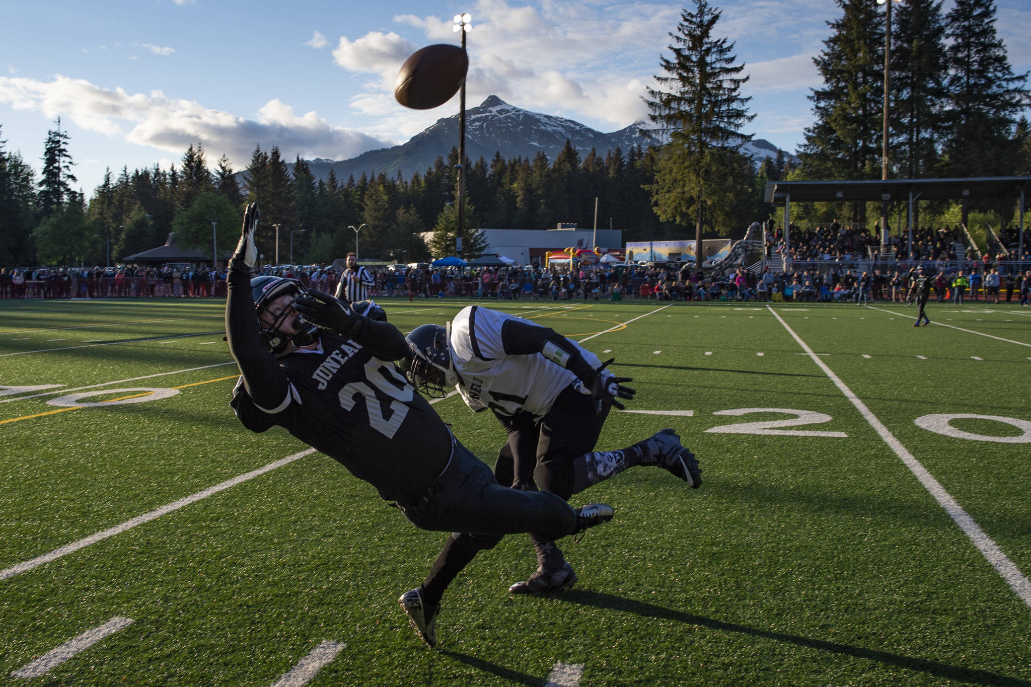 Legends’ Willy Dodd makes a catch that was ruled out of bounds during the Juneau Alumni Football Game with football players, dance team members and cheerleaders from Juneau-Douglas and Thunder Mountain High Schools at Adair-Kennedy Memorial Field on Friday, May 24, 2019. (Michael Penn | Juneau Empire)