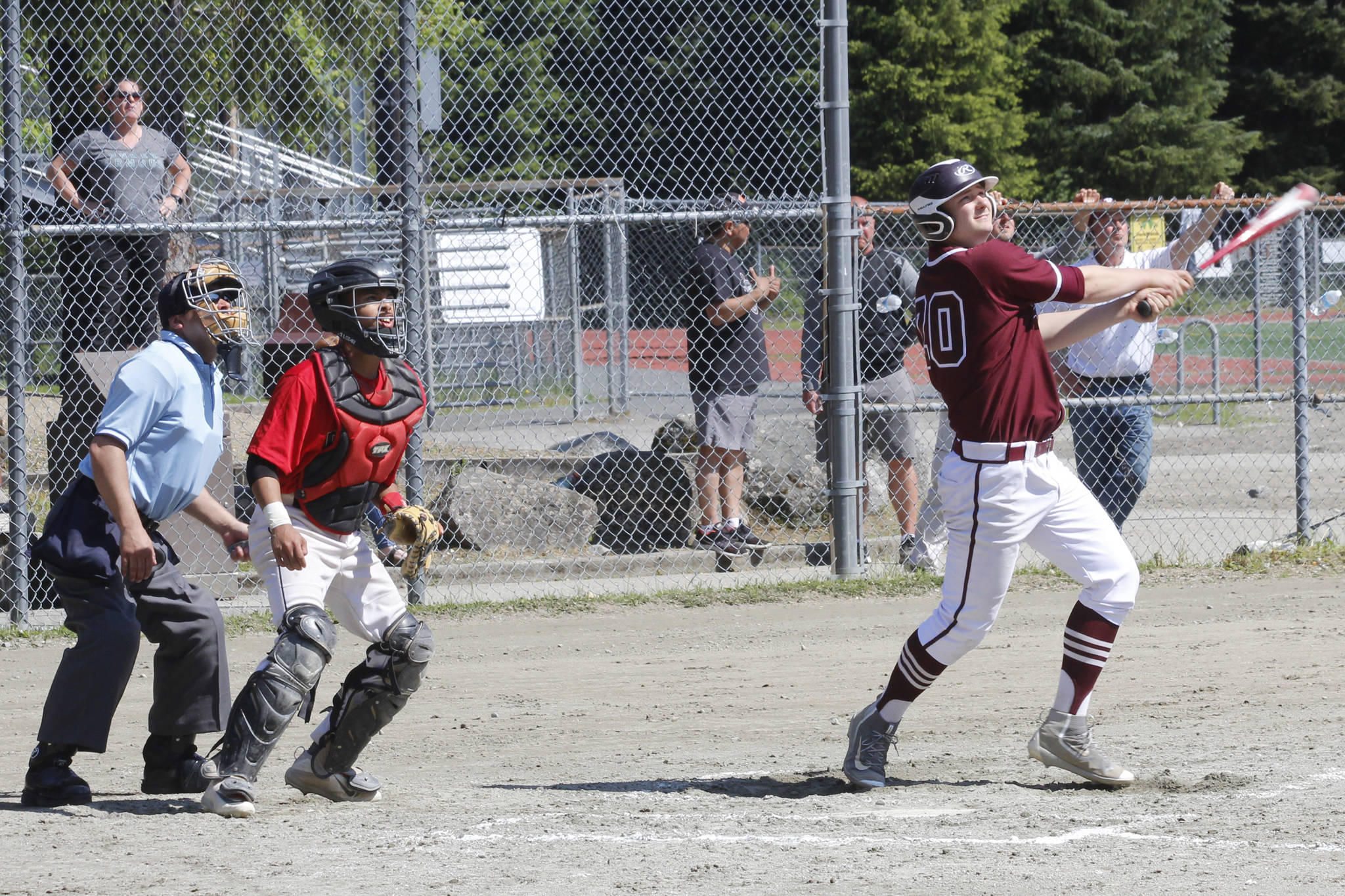 Ketchikan’s Wyatt Barajas watches a grand slam home run off his bat in the Region V title game on Saturday, May 25, 2019. (Alex McCarthy | Juneau Empire)