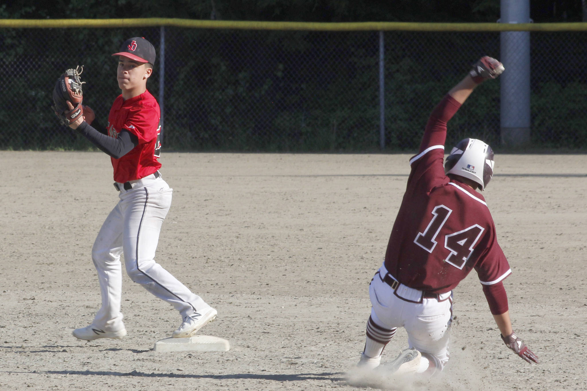 Juneau-Douglas High School: Yadaa.at Kale second baseman Gaby Soto forces out Ketchikan’s C.J. Paule during the Region V title game against Ketchikan on Saturday, May 25, 2019. (Alex McCarthy | Juneau Empire)