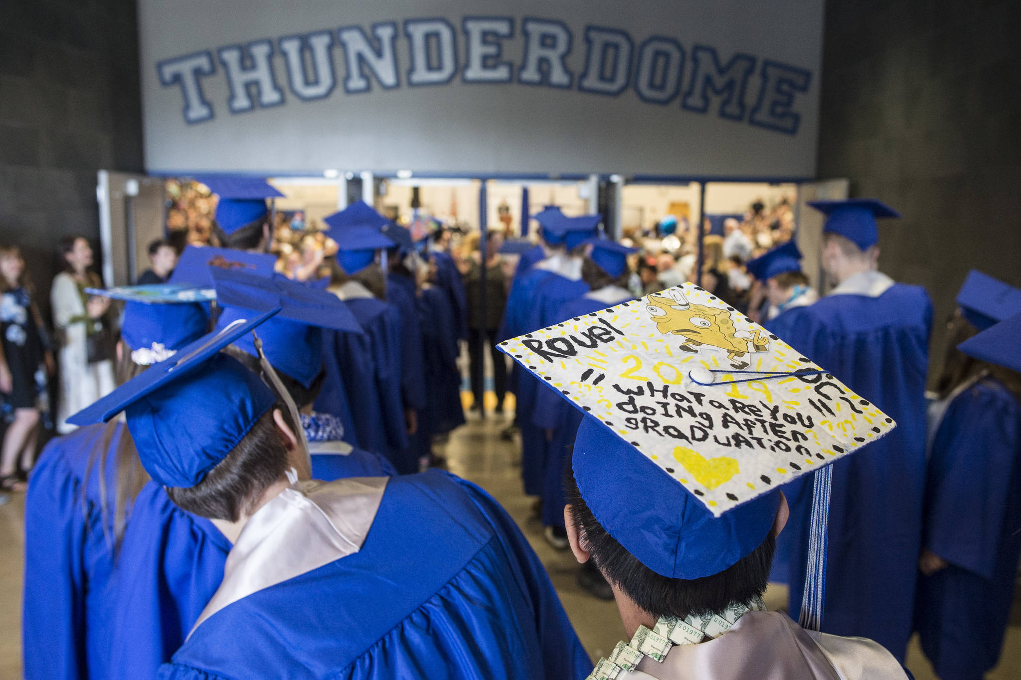 Thunder Mountain High School seniors file into the gymnasium for their graduation on Sunday, May 26, 2019. (Michael Penn | Juneau Empire)