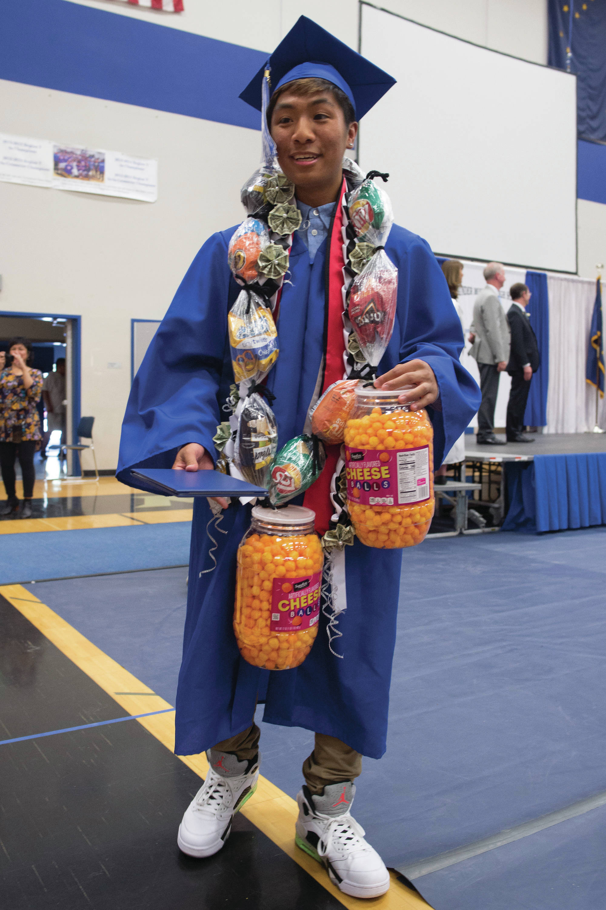 Bernard Yadao gets his diploma and numerous treats from his family during Thunder Mountain High School graduation on Sunday.