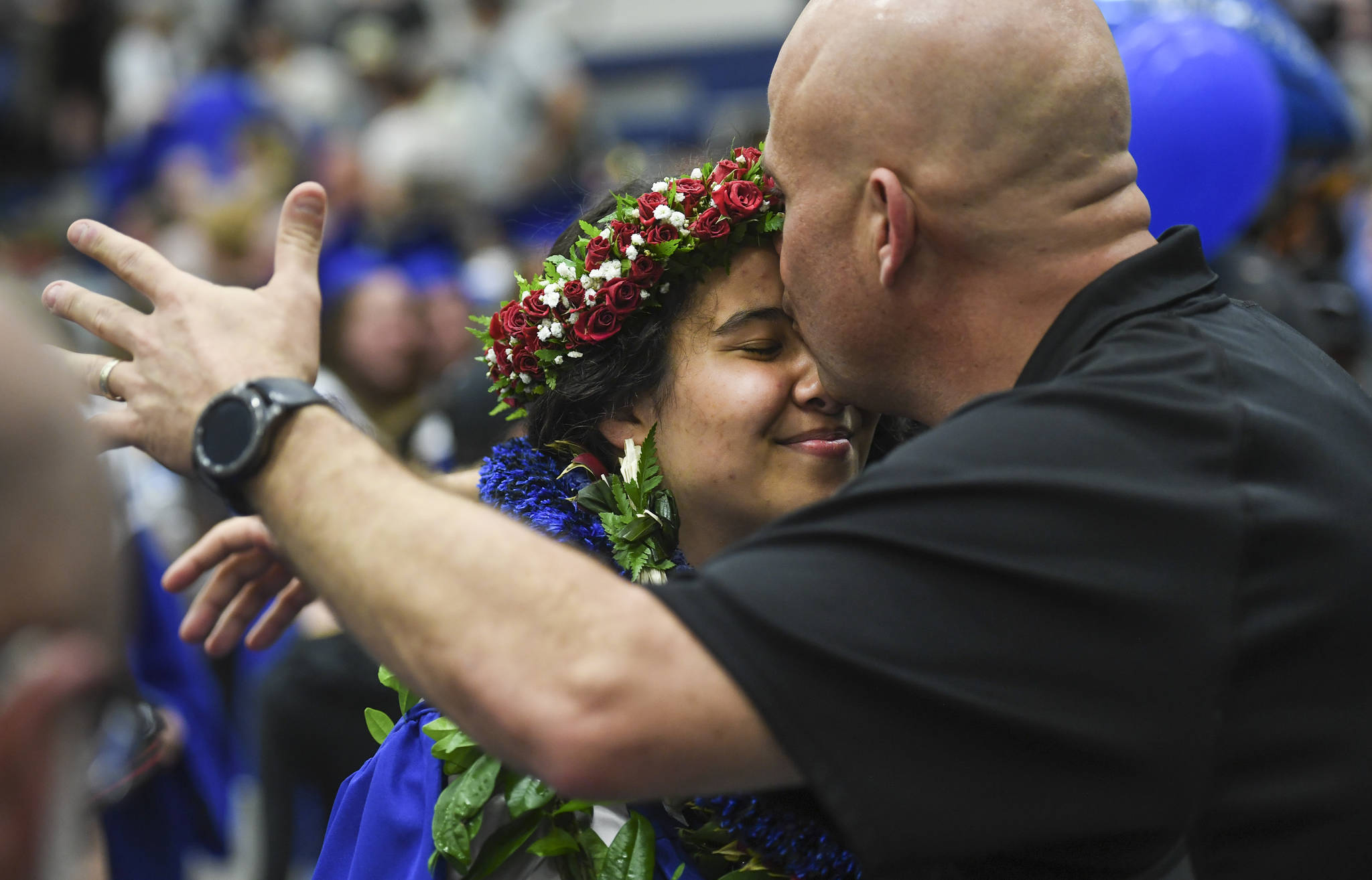 Kaili DeMello receives a kiss from her father, Jeremy, after the Thunder Mountain High School graduation on Sunday, May 26, 2019. (Michael Penn | Juneau Empire)