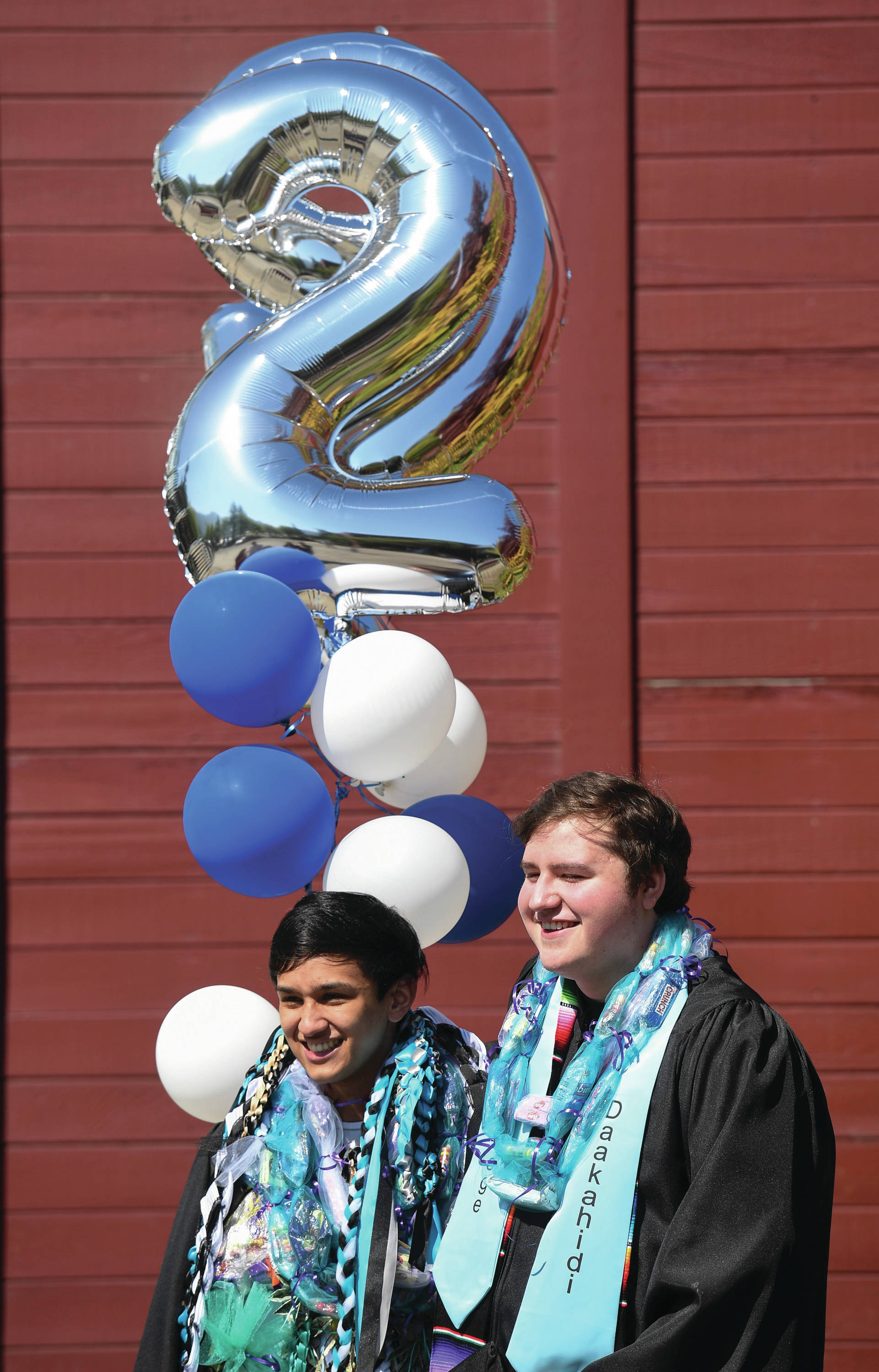 Diego Rivera, left, and Christian Kensinger pose for a picture after the Yaakoosgé Daakahidi High School graduation at Centennial Hall on Sunday.
