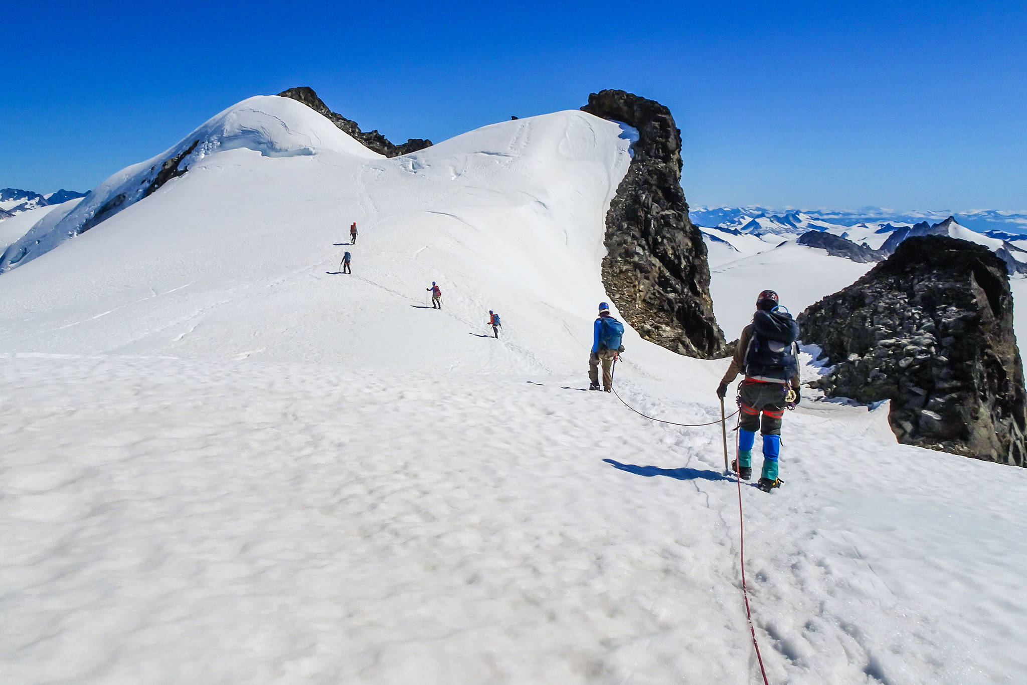 Juneau Icefield Research Program students and faculty approach an unnamed mountain last summer. U.S. Fish and Wildlife Service Cartographer Scott McGee is proposing the name Gorgon Spire for the mountain through the Alaska Historical Commission. (Courtesy Photo | Scott McGee)