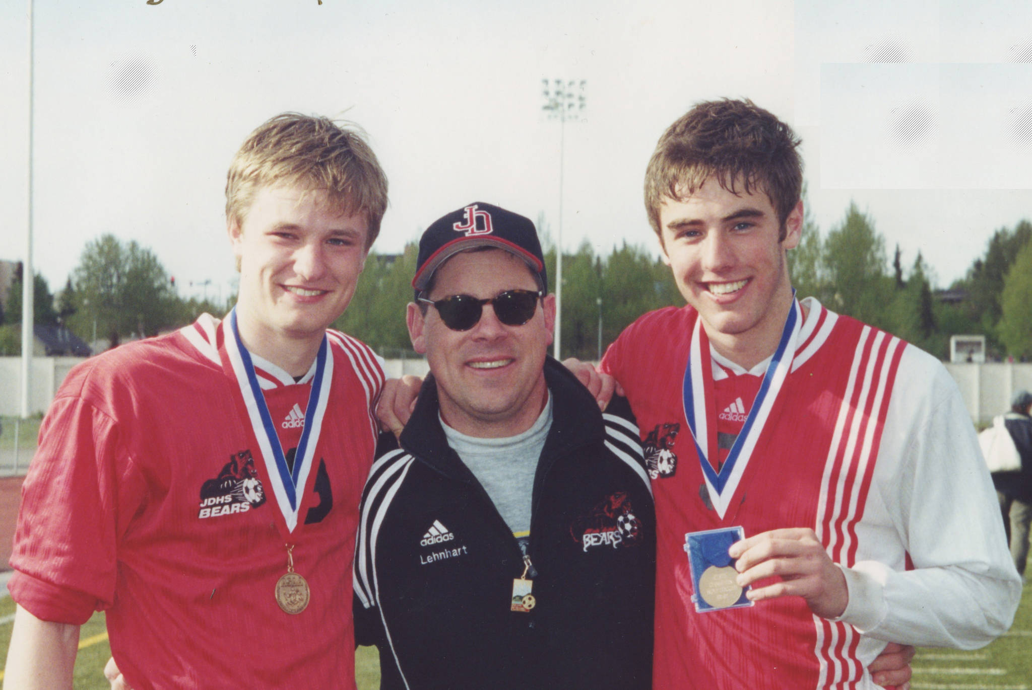 Courtesy Photo | <strong>Susan Knowles</strong>                                Juneau-Douglas High School soccer coach Gary Lehnhart, center, poses senior Justin Dorn, left, and Luke Knowles following the Crimson Bears’ win over Dimond in the 2001 state championship in Anchorage. Dorn was inducted into the ASAA High School Hall of Fame on May 5.