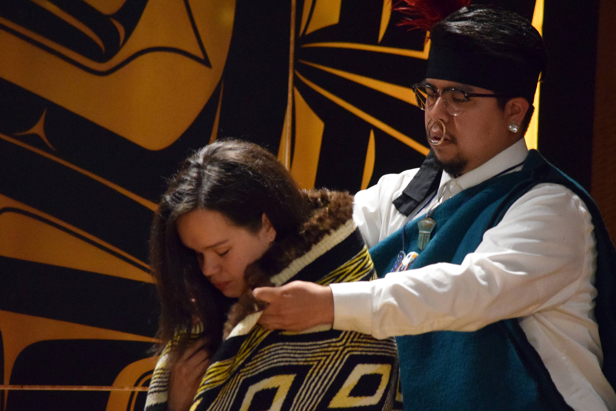 Lily Hope has a robe woven by her mother, Clarissa Rizal, placed on her shoulders by Elijah Marks, Friday, May 31, 2019. (Ben Hohenstatt | Juneau Empire)