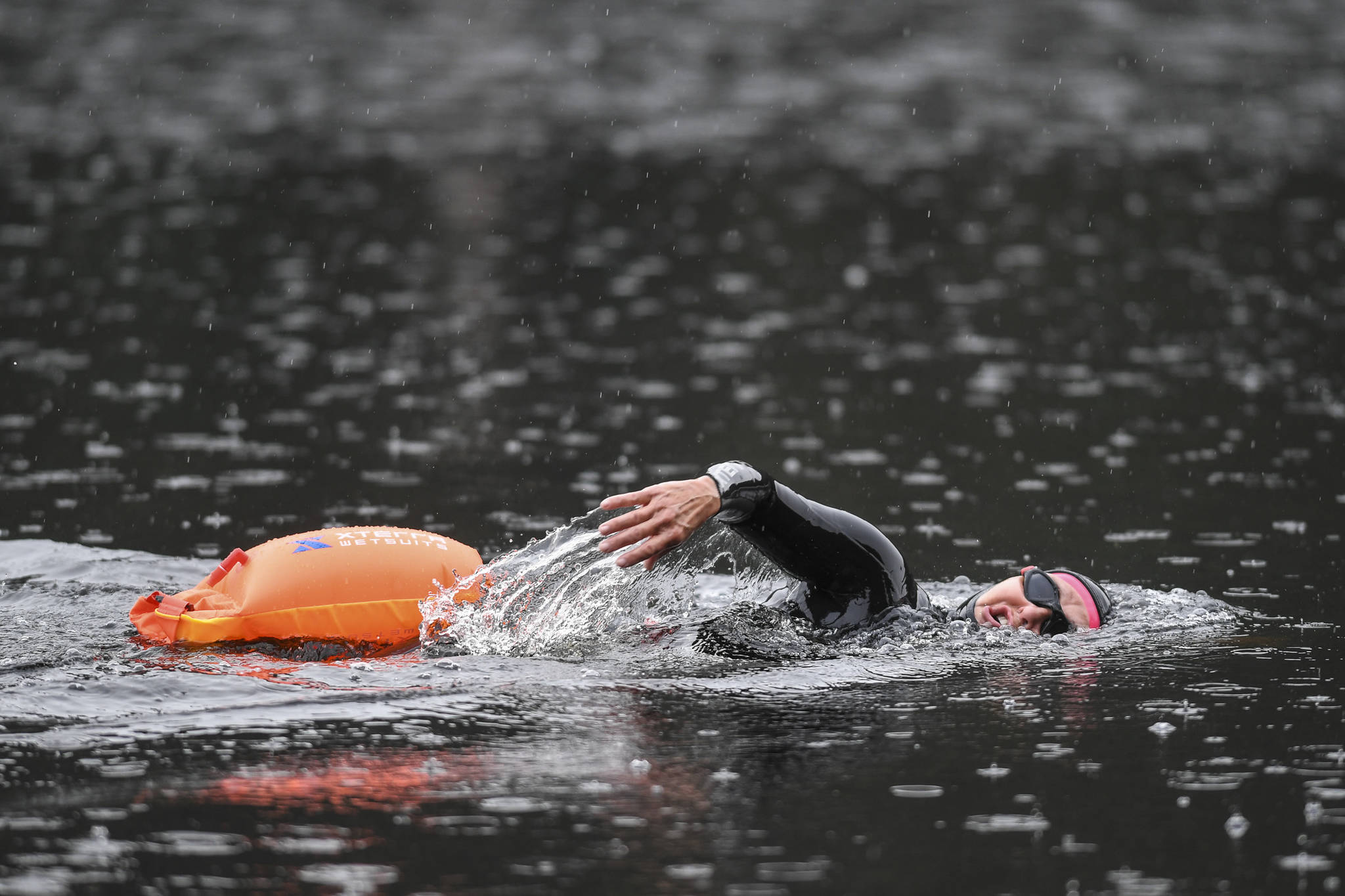 Triathlon coach Jamie Bursell swims in Auke Lake on Wednesday, June 5, 2019. (Michael Penn | Juneau Empire)