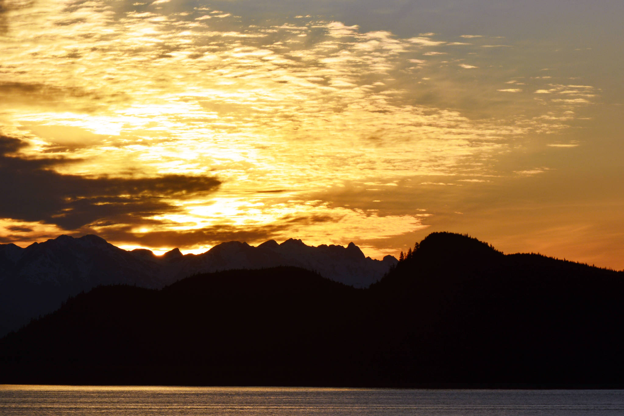The sun sets with Lincoln Island and the Chilkat Peninsula in the background, in the last week of May. (Courtesy photo | Jerry Reinwand)