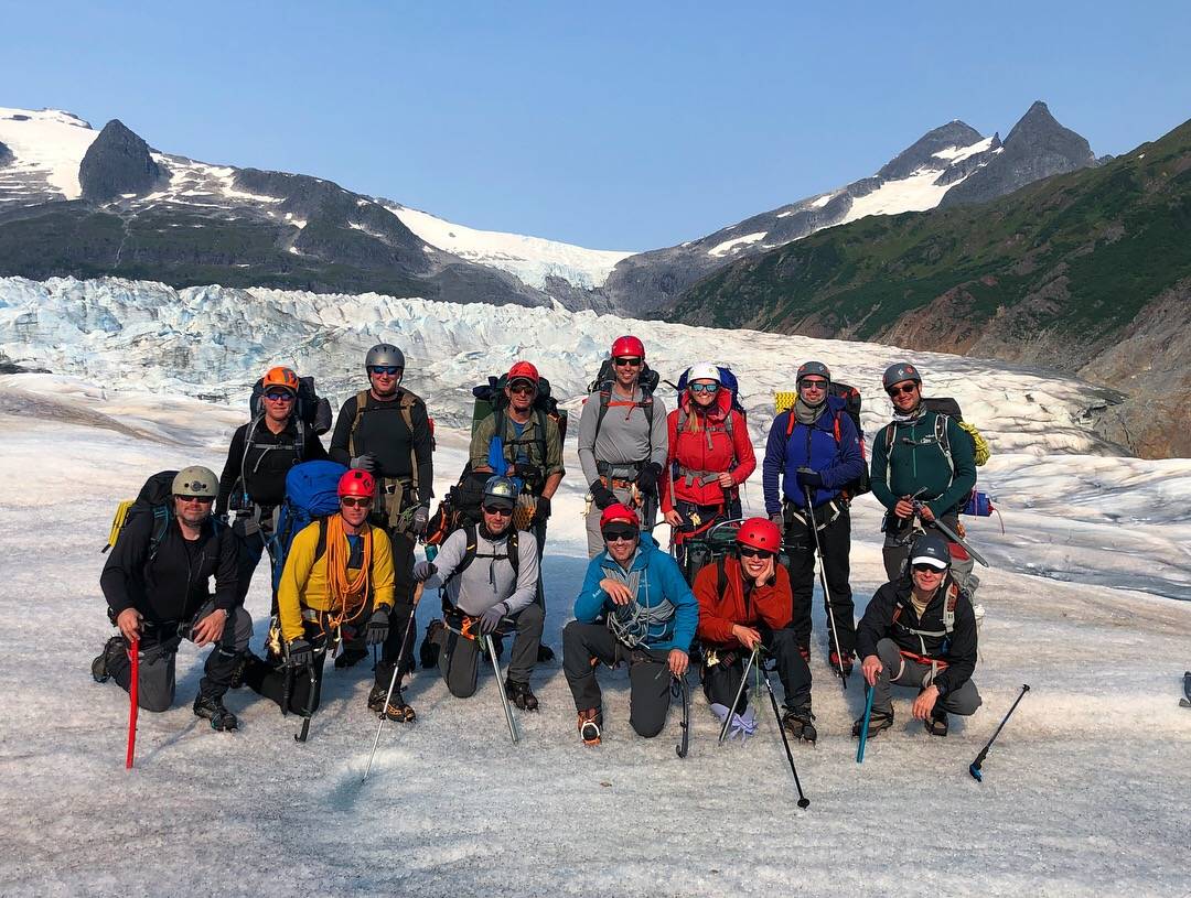 Bill Dean (front row, yellow coat) poses for a photo with a group on a leadership excursion on the Mendenhall Glacier in 2017. (Courtesy photo | Maggie Ward)