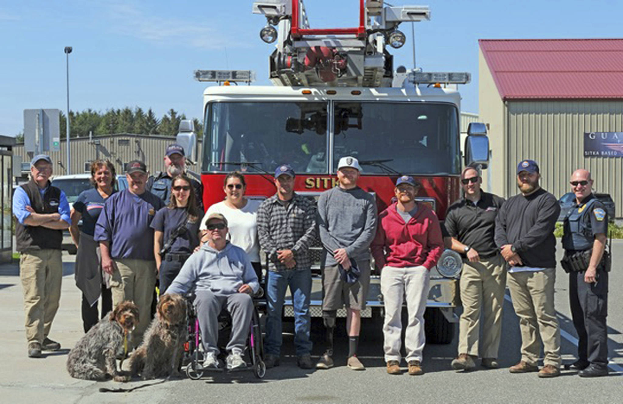 In this Saturday, May 25 photo, military veterans from Freedom Alliance are greeted at the Sitka airport by local fire and police personnel as they start a week of adventure at Vonnie’s Charters and Halibut Point Lodge. Often overlooked in conflicts that occur thousands of miles away on continents most people see just on social media, are the military veterans who return to their non-service lives with traumas both visible and unseen. A local fishing charter business, working with a veteran support organization called Freedom Alliance, has been reaching out to these veterans over the past several years, giving them a taste of all that Alaska has to offer. (Klas Stolpe | Sitka Sentinel via AP)