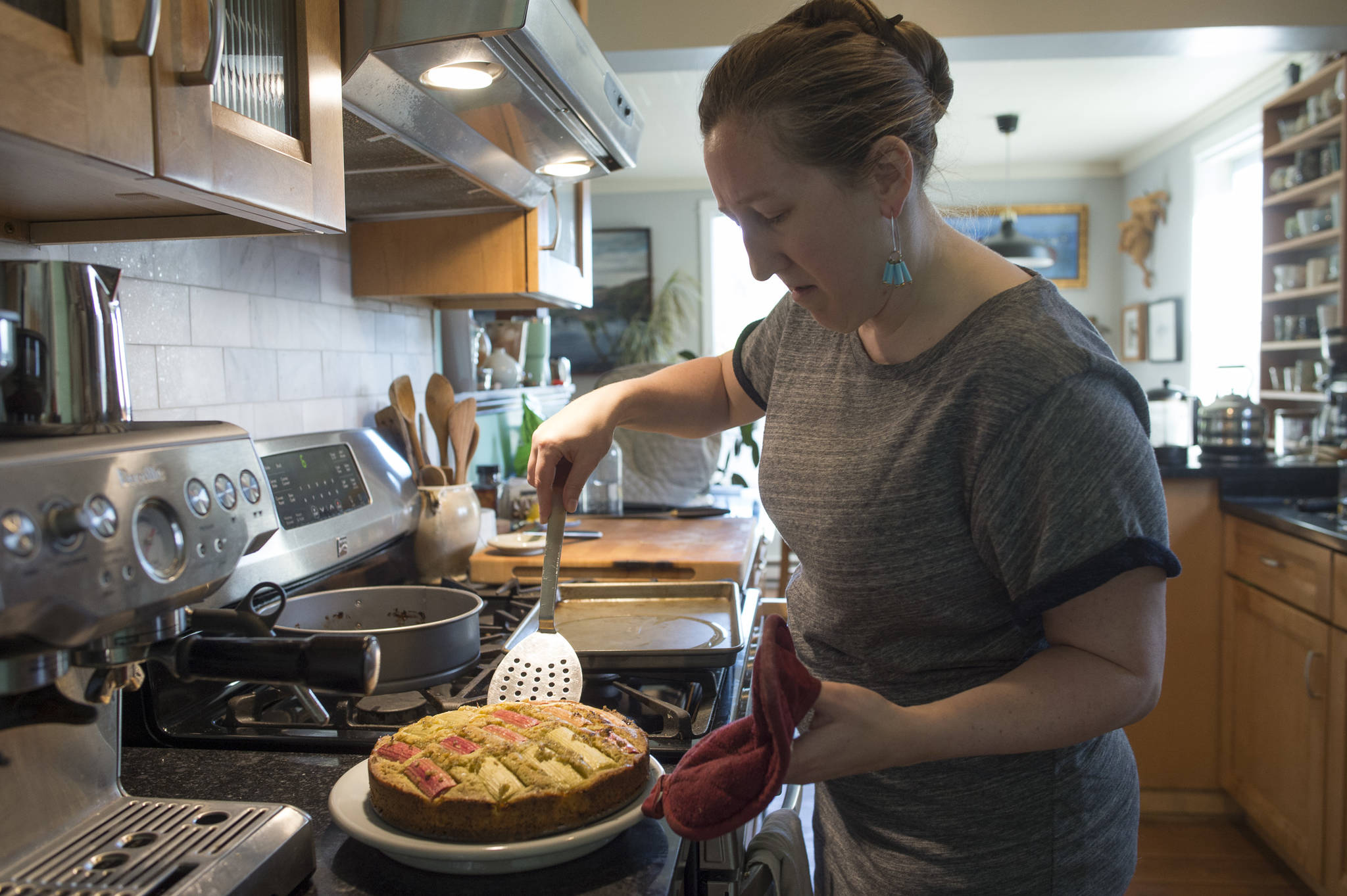 Erin Anais Heist prepares spruce tip rhubarb cake in her home kitchen on Thursday, June 6, 2019. (Michael Penn | Juneau Empire)