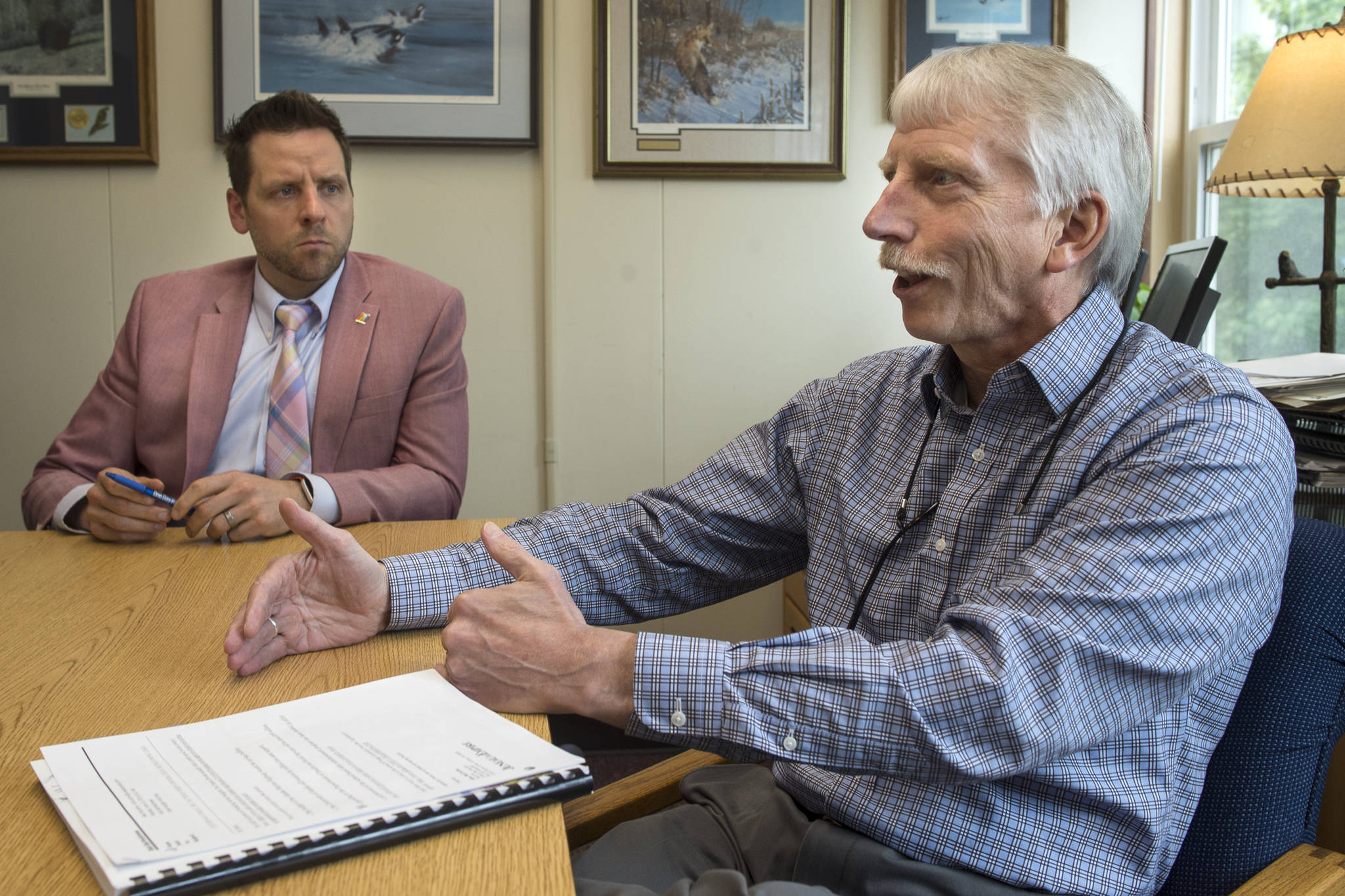 City and Borough of Juneau outgoing Finance Director Bob Bartholomew, right, and incoming Finance Director Jeff Rogers, talk about the legislature’s budget bill’s effect on the city’s budget at City Hall on Monday, June 10, 2019. (Michael Penn | Juneau Empire)