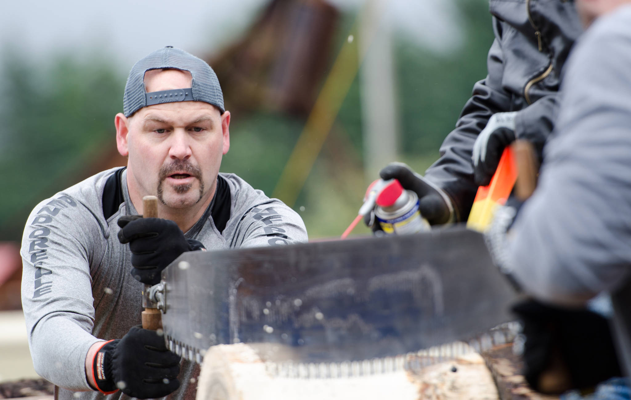 Dominic Hoy competes in the men’s team hand bucking during the 28th annual Juneau Gold Rush Days at Savikko Park. (Konrad Frank | Juneau Empire File)