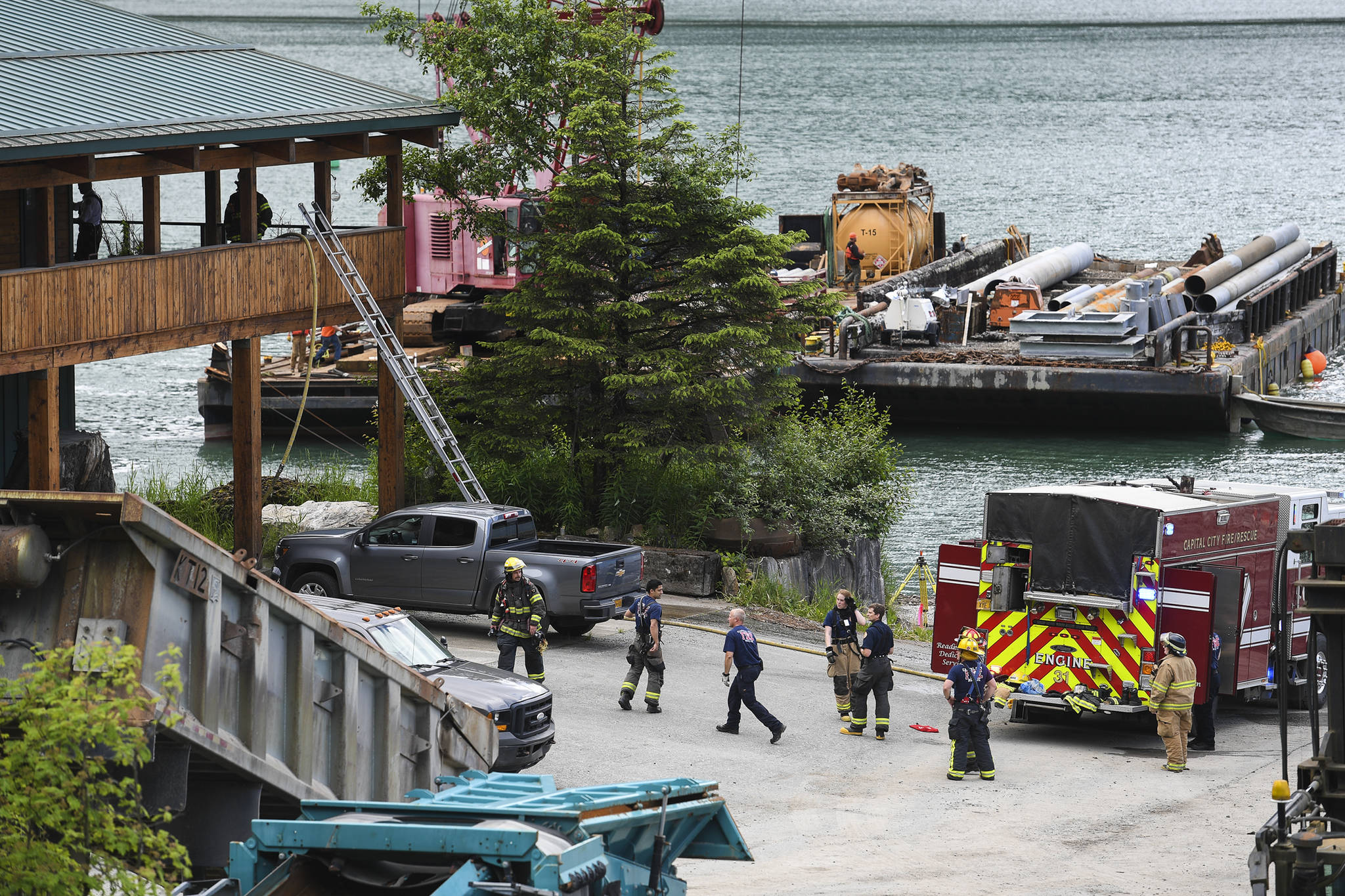 Capital City Fire/Rescue personnel attend to a fire found at an apartment on Channel Drive on Thursday, June 13, 2019. (Michael Penn | Juneau Empire)
