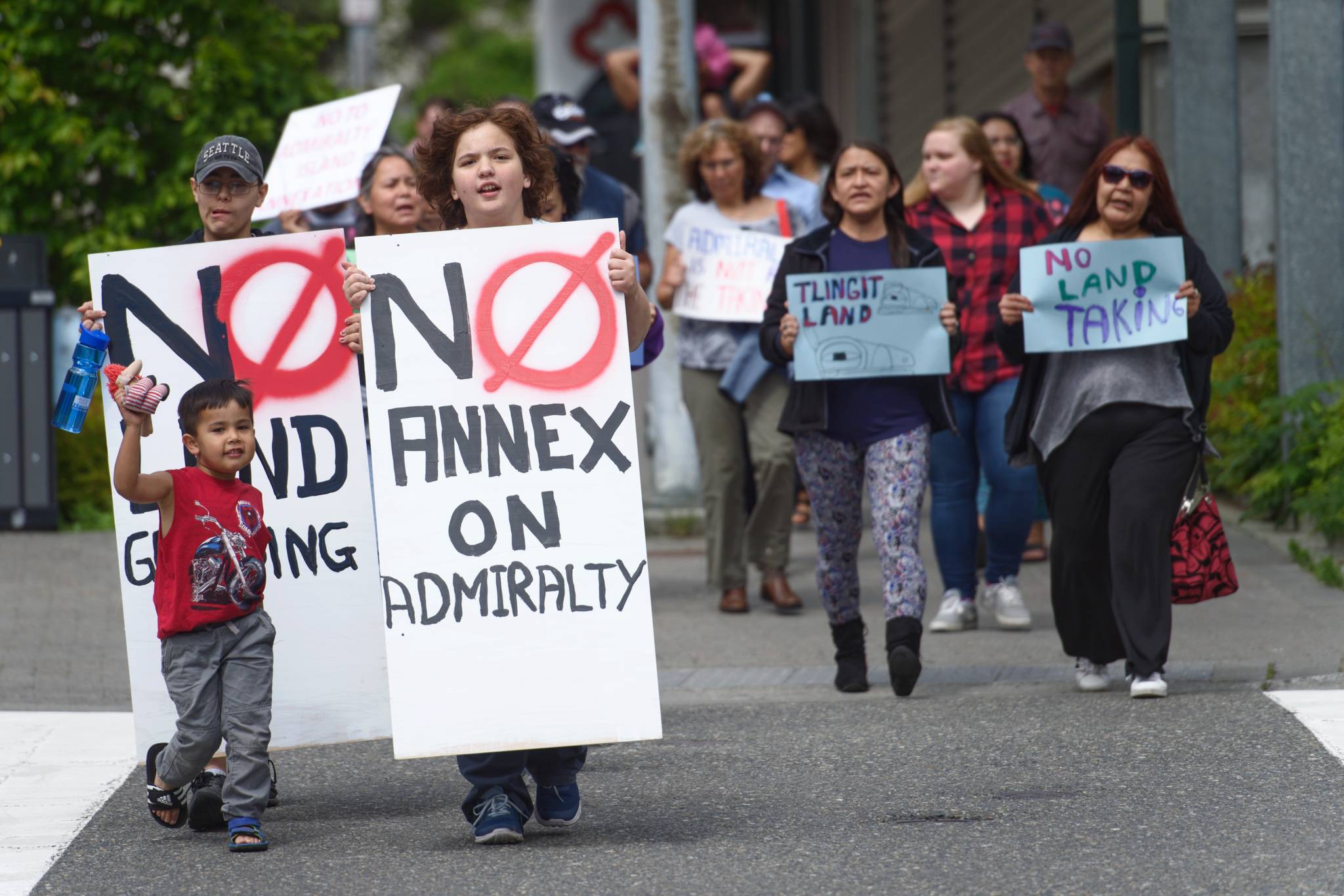 Protesters walk down Main Street in Juneau to protest against the City and Borough of Juneau’s annexation of parts of Admiralty Island on Friday, June 14, 2019. (Michael Penn | Juneau Empire)