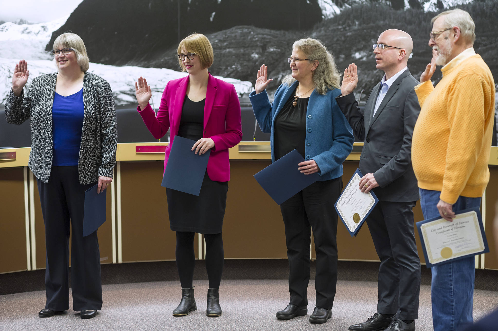 Mayor Beth Weldon, left, Carole Triem, Michelle Bonnet Hale, Wade Bryson and Loren Jones are sworn in to their new positions on the Juneau Assembly on Monday, Oct. 15, 2018. (Michael Penn | Juneau Empire File)