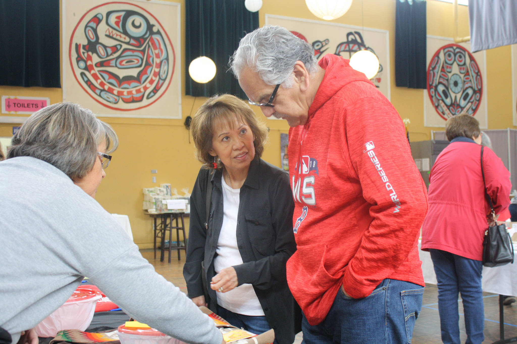 John and Kathy Lawrence look at various raffles during a fundraiser for Alex Cesar at the Juneau Arts and Culture Center on Saturday, June 15, 2019. (Nolin Ainsworth | Juneau Empire)