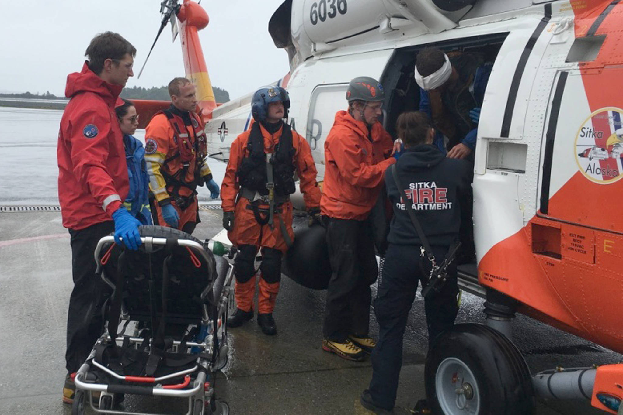 A Coast Guard Air Station Sitka MH-60 Jayhawk helicopter crew transfers an injured hiker to awaiting emergency medical services in Sitka, Alaska, June 15, 2019. The 55-year-old man required medical evacuation after reportedly falling 100 feet while hiking in the Sisters Mountains with two other people. (Courtesy photo | U.S. Coast Guard)