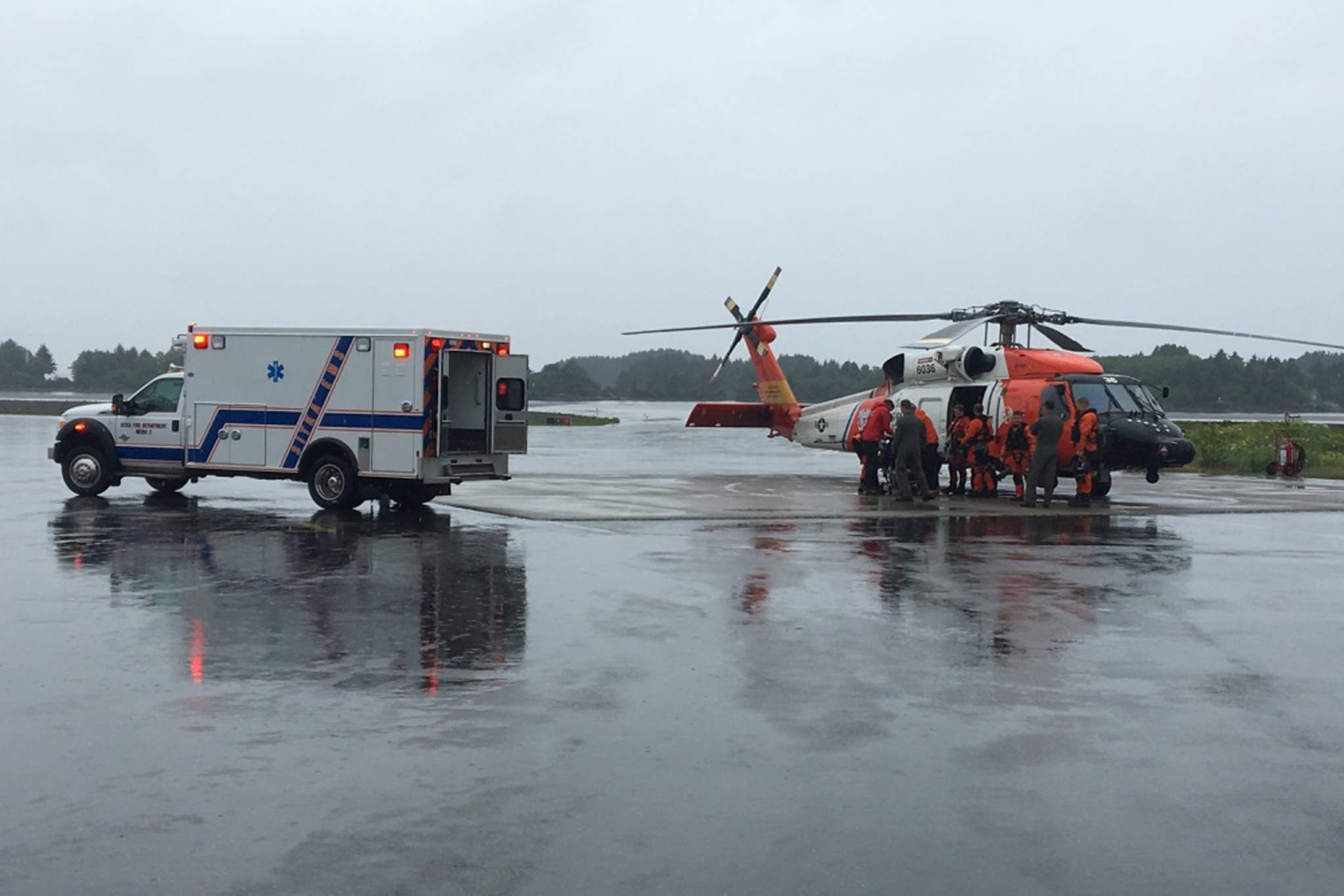 A Coast Guard Air Station Sitka MH-60 Jayhawk helicopter crew transfers an injured hiker to emergency medical services for further care in Sitka, Alaska, June 15, 2019. The man was reported to have fallen 100 feet while hiking in the Sisters Mountains in Sitka with two other people and he required rescue. (Courtesy photo | U.S. Coast Guard)