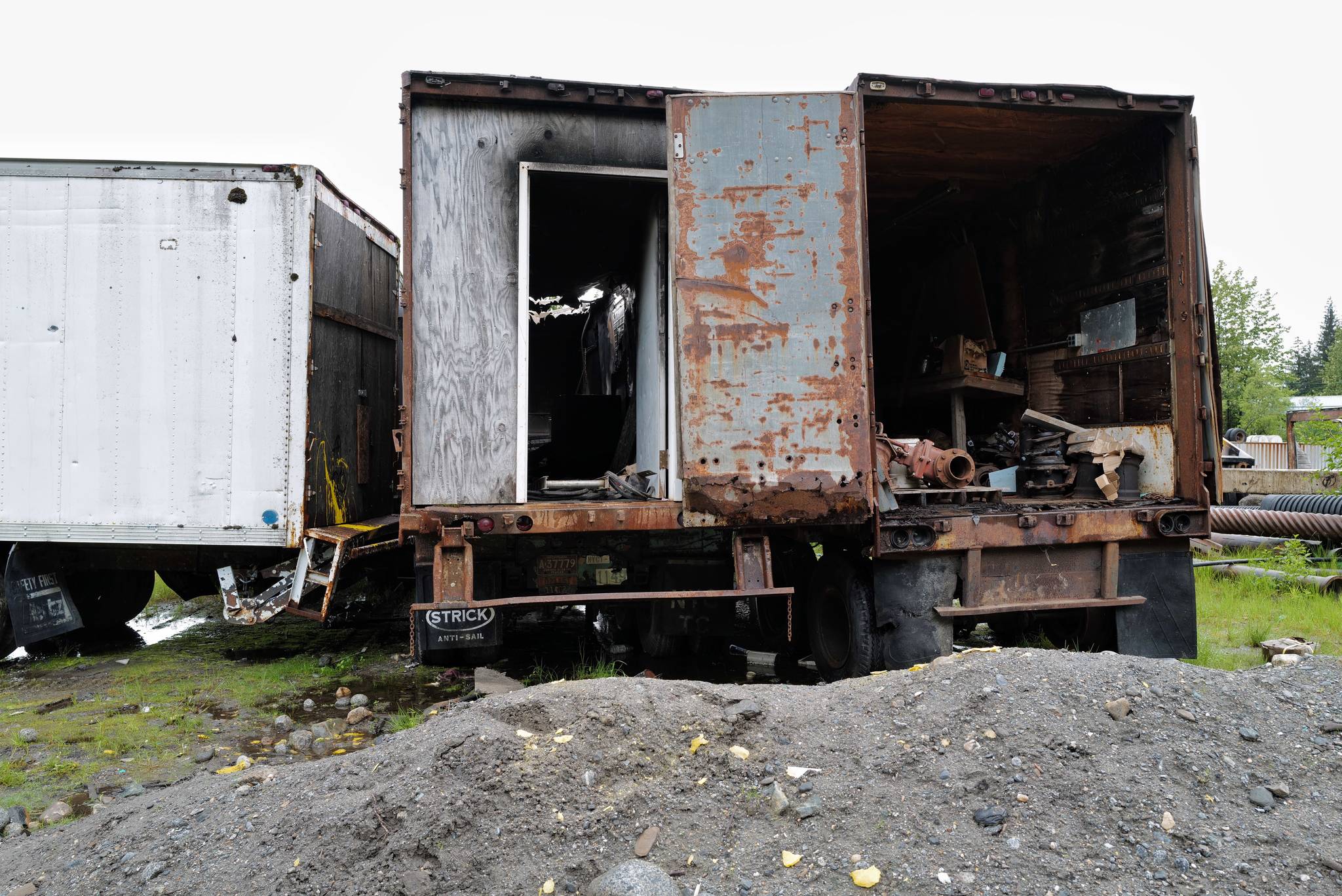Shipping containers are pictured in a lot on Valley Boulevard on Tuesday, June 18, 2019. Capital City Fire/Rescue responded to fire set in two of the containers on Monday. (Michael Penn | Juneau Empire)