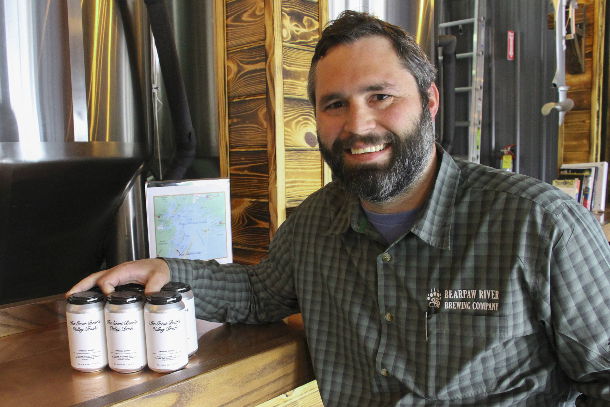 This June 14, 2019, photo shows Jake Wade, the owner and operator of Bearpaw River Brewing Co., posing for a photo in his craft brewery in Wasilla, Alaska. The brewery has begun making the Valley Trash ale, using the original recipe from another brewery that went out of business. The name of the beer harkens back to a slur cast on residents of the Matanuska-Susitna Borough by former state Sen. Ben Stevens, an Anchorage Republican who now serves as an aide to Alaska Gov. Mike Dunleavy. (AP Photo/Mark Thiessen)