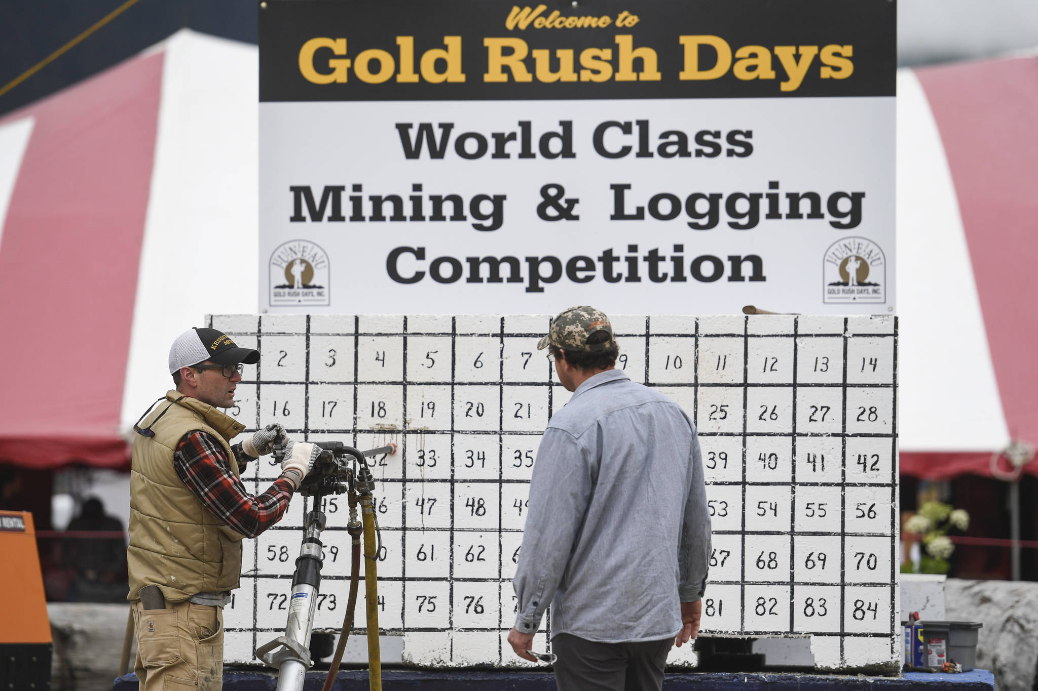 Jesse Stringer, left, explains the jackleg drill to fellow contestant Jesse Ross in the Mining & Logging Competition at the 29th Annual Gold Rush Days at Savikko Park on Saturday, June 22, 2019. (Michael Penn | Juneau Empire)