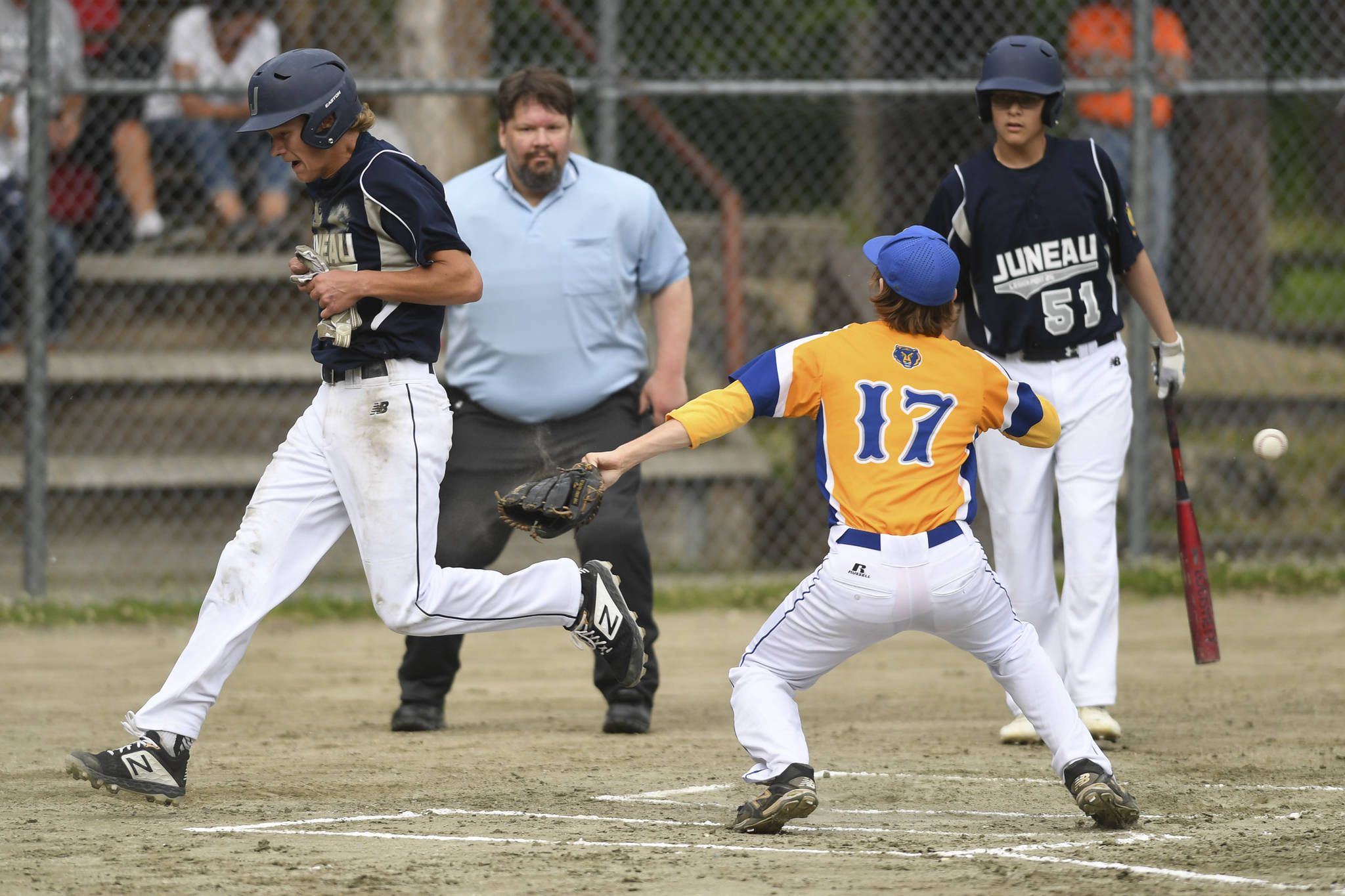 Juneau’s Gabe Storie steals home on a passed ball in the first inning against Bartlett’s pitcher Nelson Korshin in Legion League baseball at Adair-Kennedy Memorial Park on Friday, June 21, 2019. (Michael Penn | Juneau Empire)