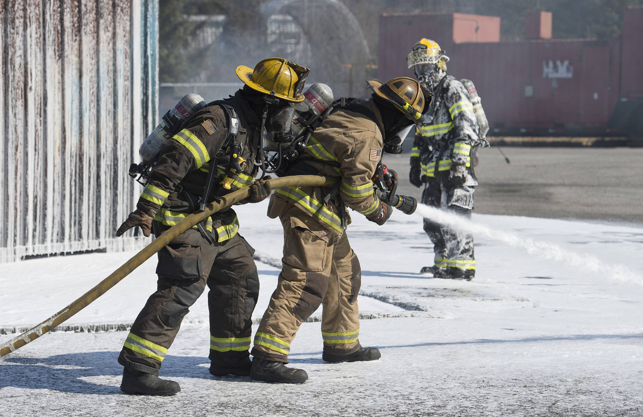 In this file photo taken April 13, 2017, Brady Fink, center, and Dave Edmunds, left, are watched by Engineer Lance Lawhorne as they update their airport rescue firefighting skills at the Hagevig Regional Fire Training Center. A potentially harmful chemical was detected at the center after soil and water testing at the center. (Michael Penn | Juneau Empire File)