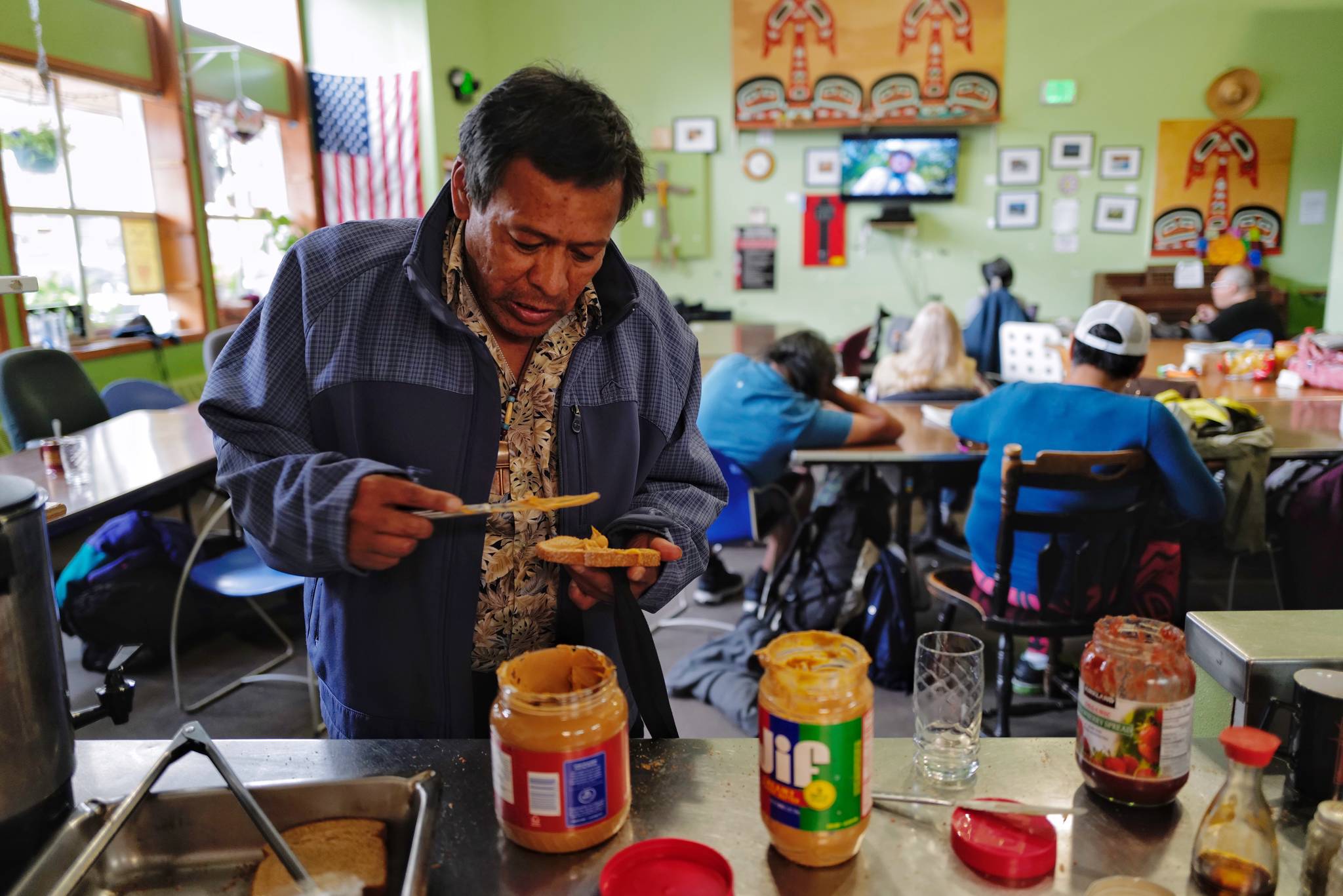 William Brown makes himself a peanut butter and jelly sandwich as he waits for dinner at the Glory Hall on Tuesday, July 2, 2019. (Michael Penn | Juneau Empire)