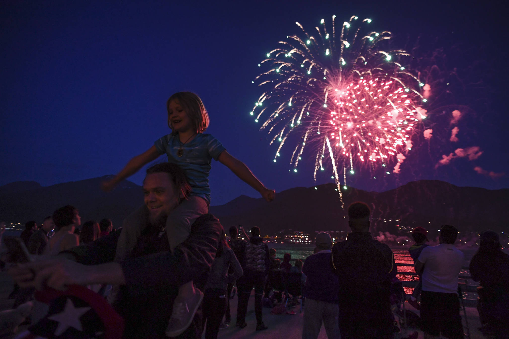 A father and daughter take a selfie as they watch the annual fireworks display on Wednesday, July 3, 2019. (Michael Penn | Juneau Empire)