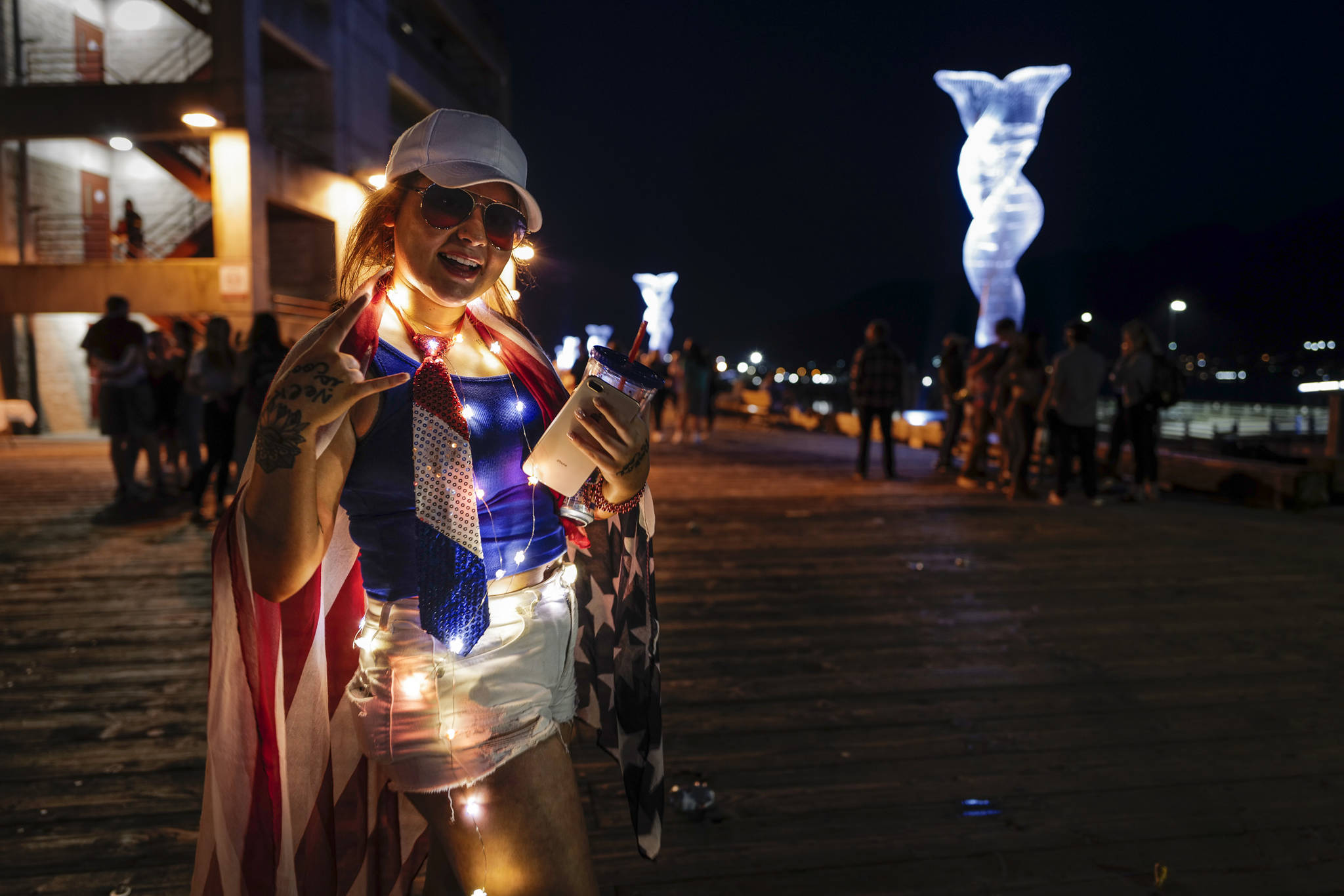 Savannah Meketa shows her patriotic spirit as Juneau residents gather around the downtown waterfront to watch the annual fireworks display on Wednesday, July 3, 2019. (Michael Penn | Juneau Empire)