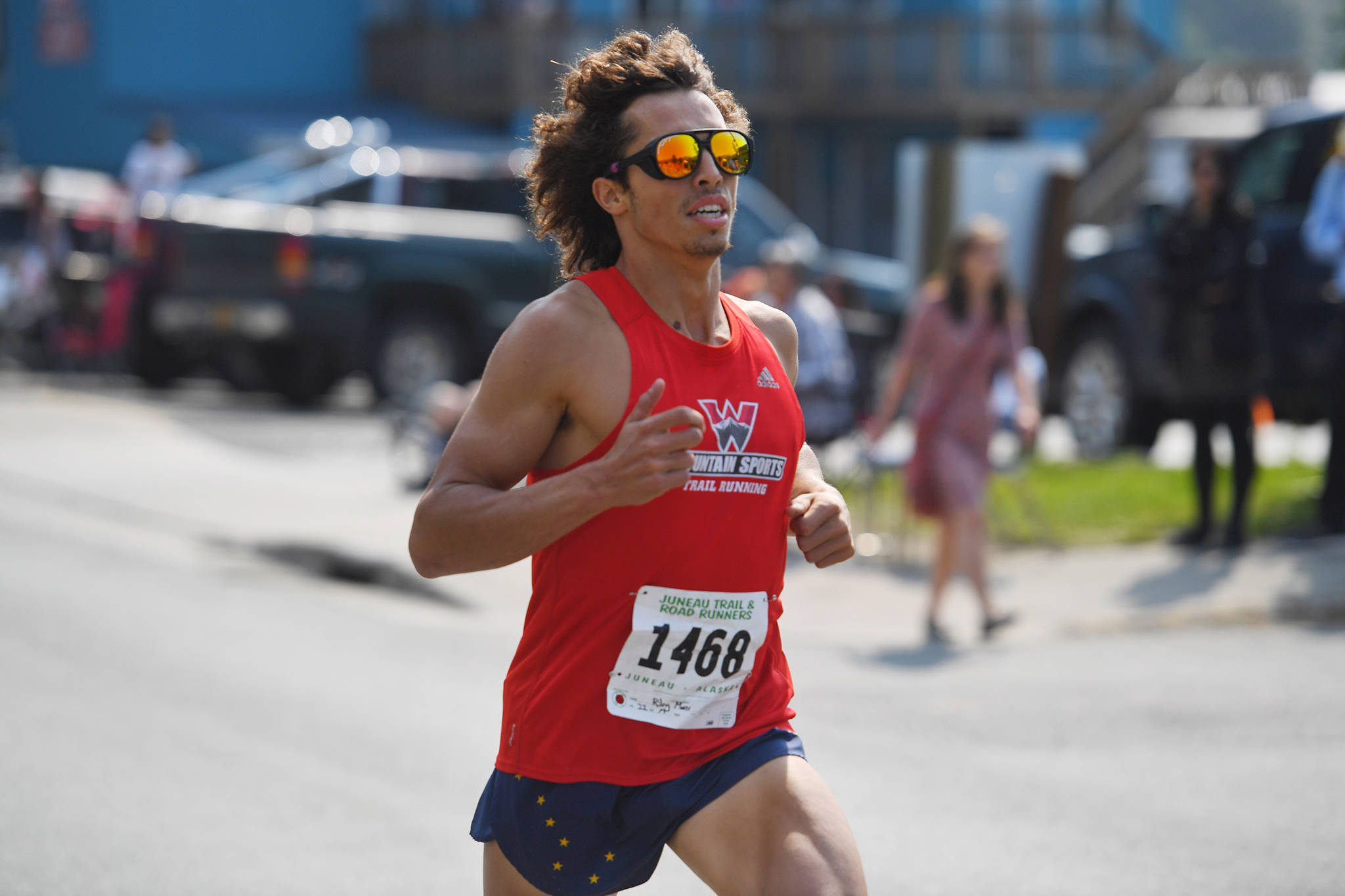 Riley Moser finishes first in the Glenn Frick Memorial Mile on Thursday, July 4, 2019. (Michael Penn | Juneau Empire)