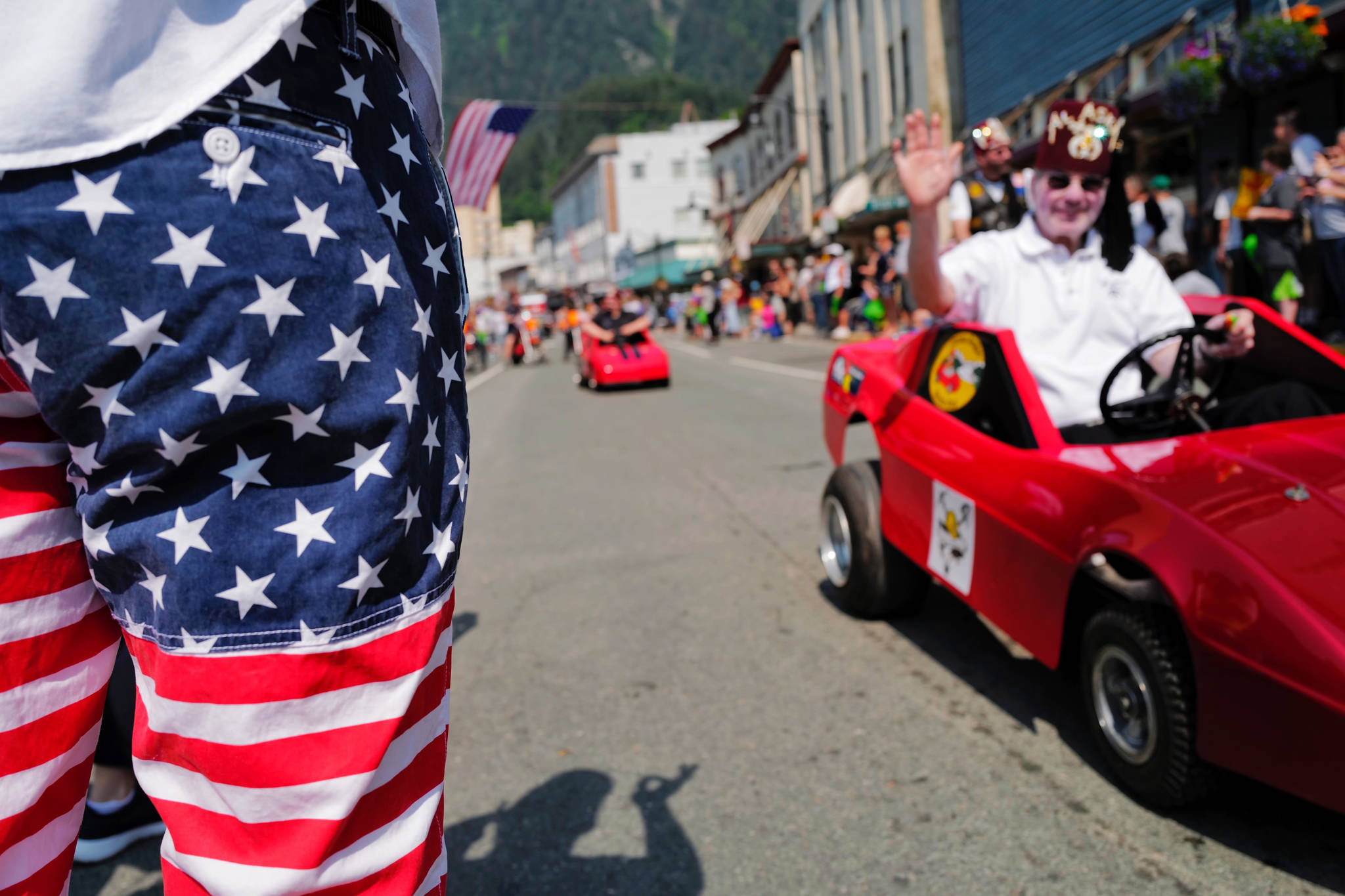 Shriners drive their little cars during the Fourth of July parade on Thursday, July 4, 2019. (Michael Penn | Juneau Empire)