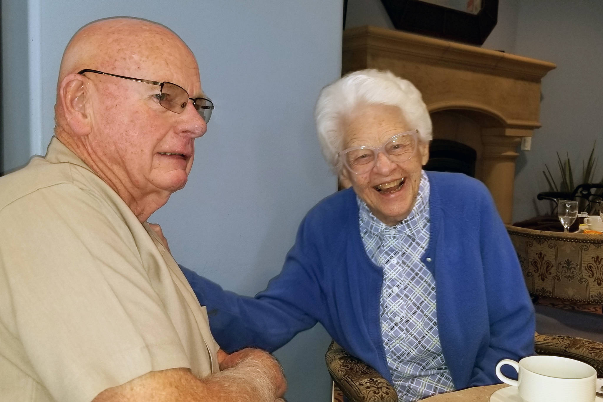 Nancy Livingston Stratford, right, laughs with Jim Wilson at her 100th birthday party in June 2019 at her home in Carlsbad, California. (Courtesy Photo | Dot Wilson)