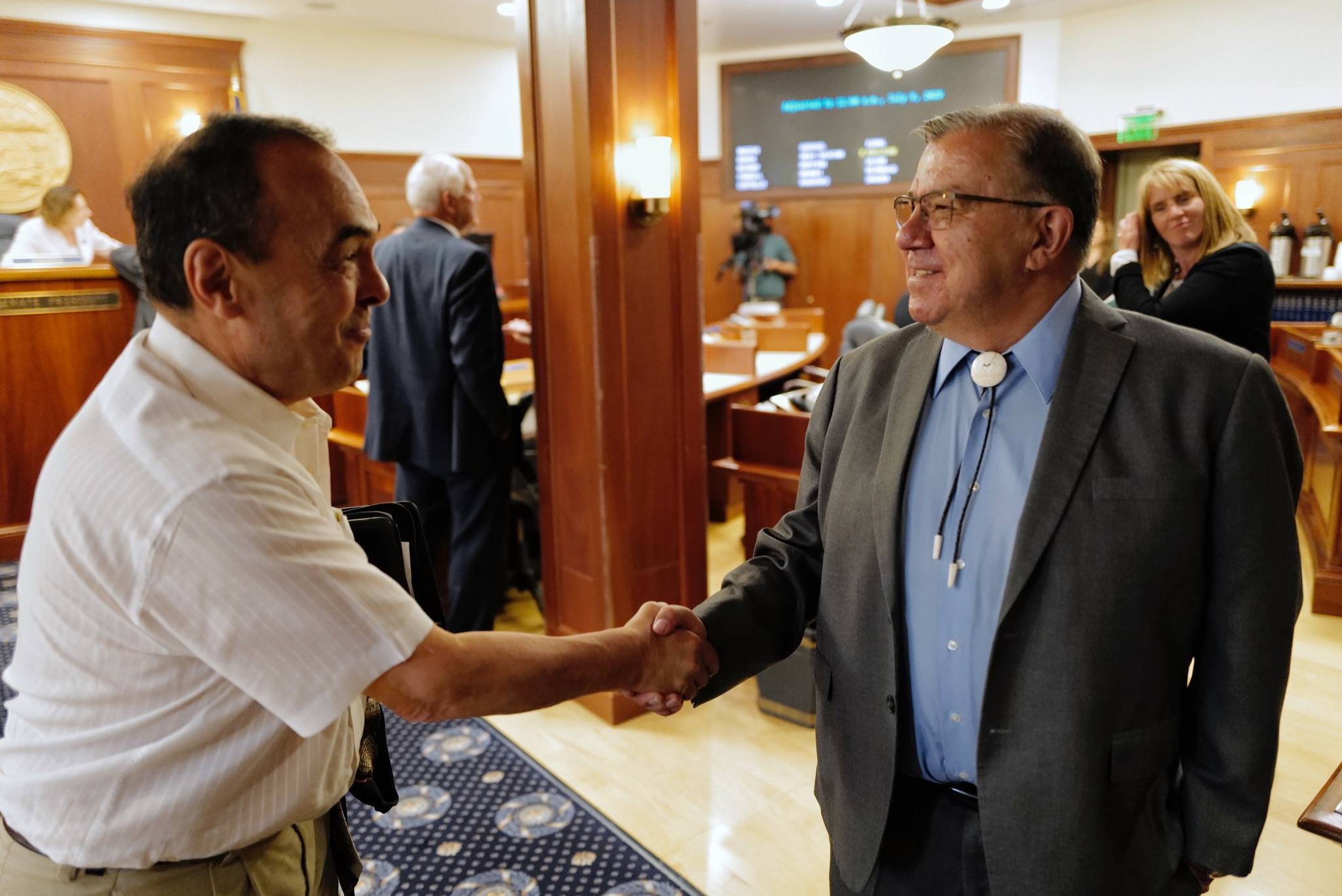 Sen. Lyman Hoffman, D-Bethel, right, is congratulated by Sen. Donny Olson, D-Golovin, after the Senate Rule Committee voted to name him the new Senate Majority Leader, replacing Sen. Mia Costello, R-Anchorage, at the Capitol on Monday, July 8, 2019. (Michael Penn | Juneau Empire)