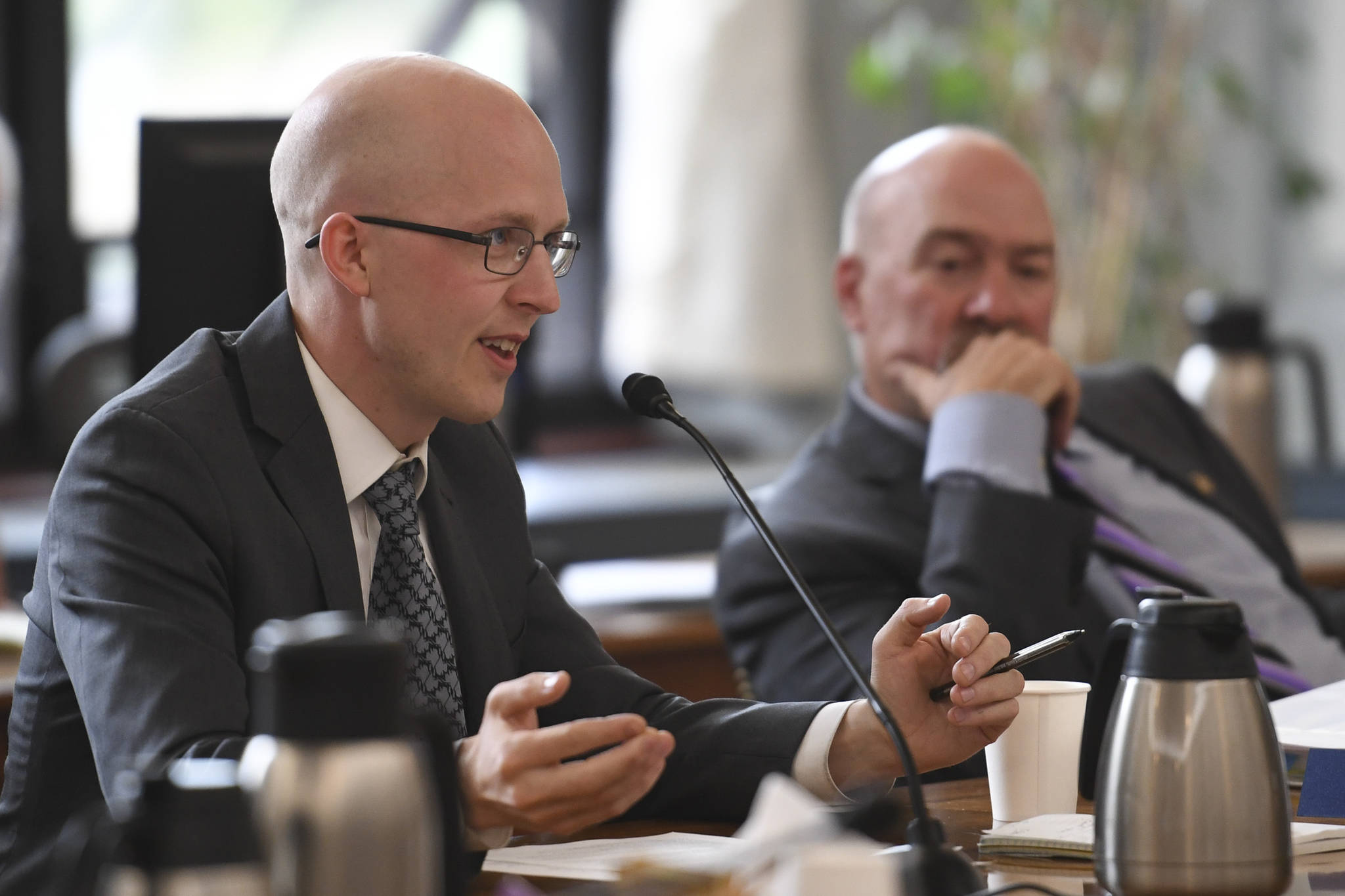Rep. Jonathan Kreiss-Tomkins, D-Sitka, present one of three papers as Rep. Adam Wool, D-Fairbanks, listens during a Bicameral Permanent Fund Working Group at the Capitol on Monday, July 8, 2019. (Michael Penn | Juneau Empire)