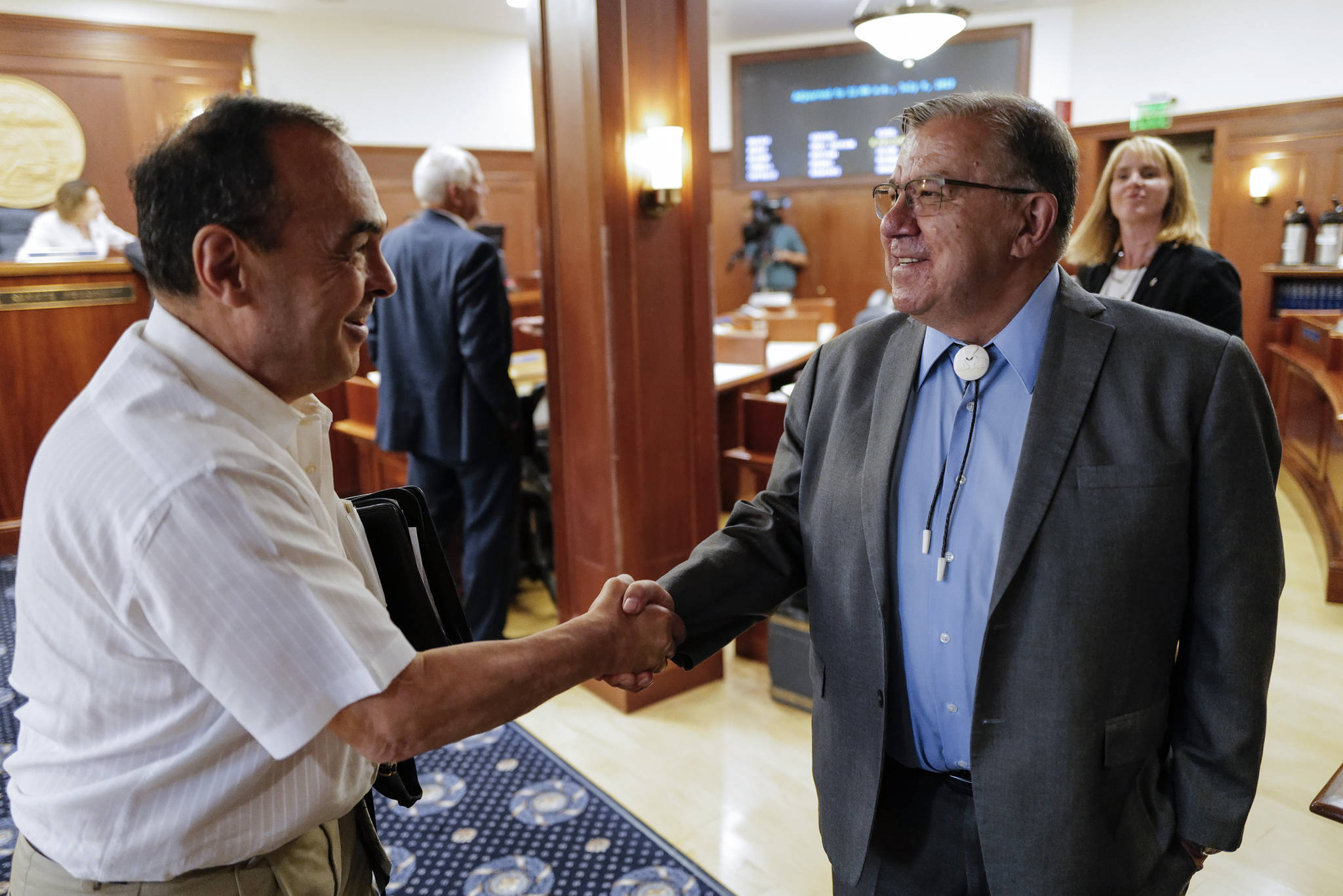 Sen. Lyman Hoffman, D-Bethel, right, is congratulated by Sen. Donny Olson, D-Golovin, after being named the new Senate Majority Leader, replacing Sen. Mia Costello, R-Anchorage, on the first day of the Second Special Session of the Alaska Legislature in Juneau on Monday, July 8, 2019. Sen. Costello joined a minority of legislators that met in Wasilla in support of Gov. Mike Dunleavy. (Michael Penn | Juneau Empire)