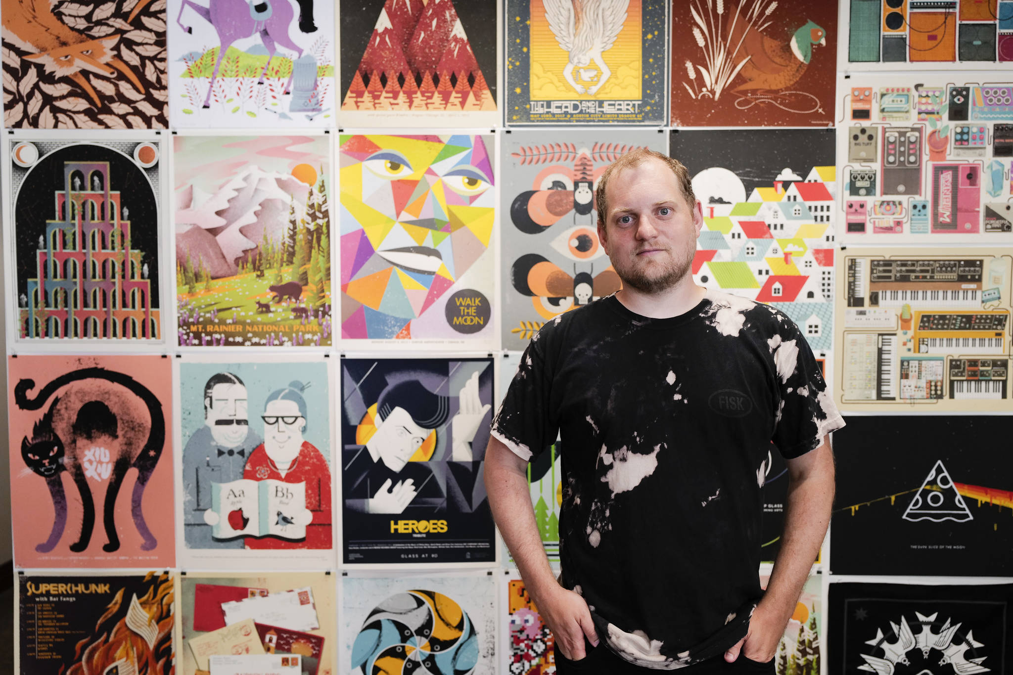 Eric Nyffeler, a designer from Portland, Oregon, stands with his work on display at Amalga Distillery for First Friday on Friday, July 5, 2019. (Michael Penn | Juneau Empire)