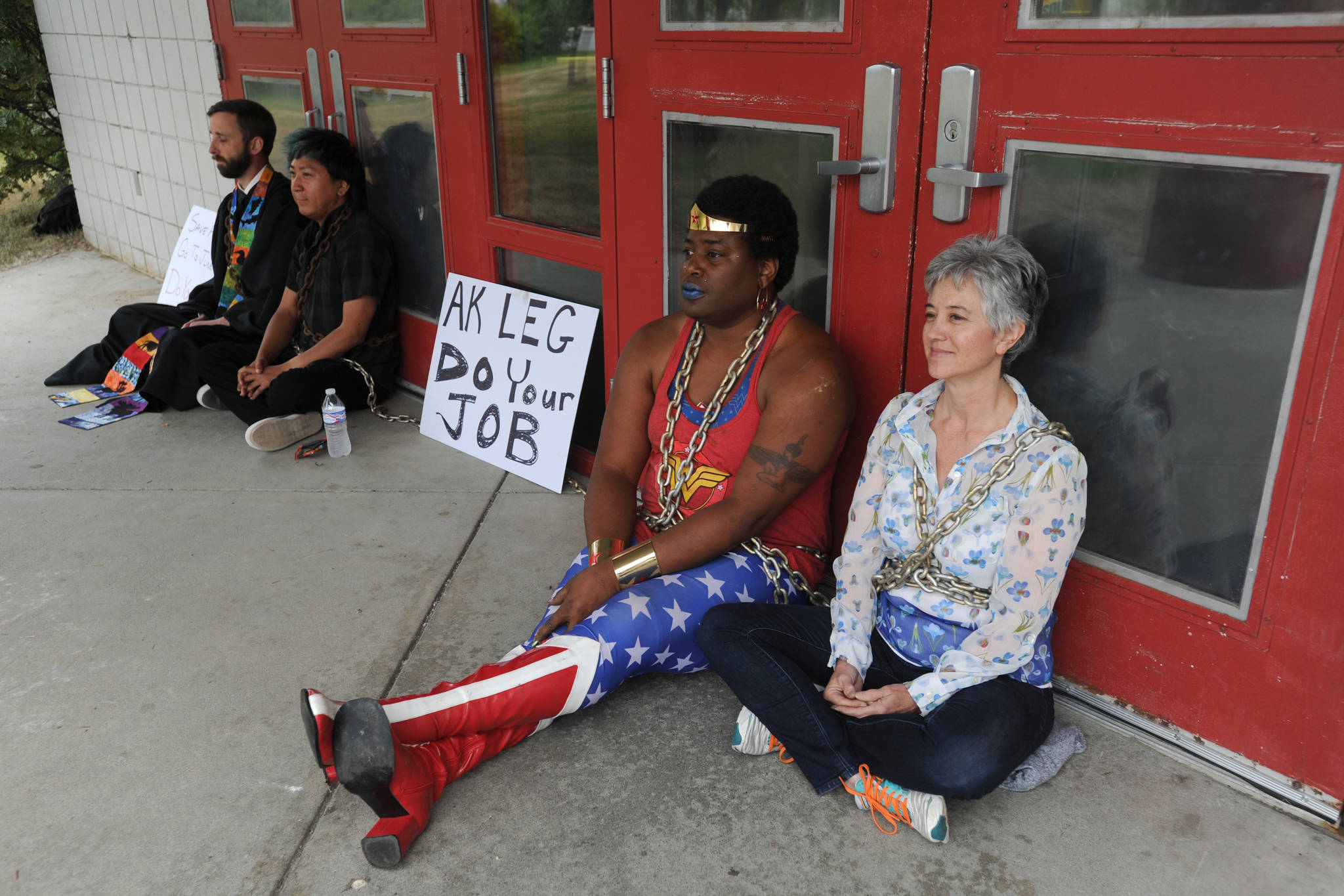 Protesters wore chains as they blocked doors at Wasilla Middle School before the legislative special session on Wednesday, July 10, 2019. (Bill Roth / ADN)
