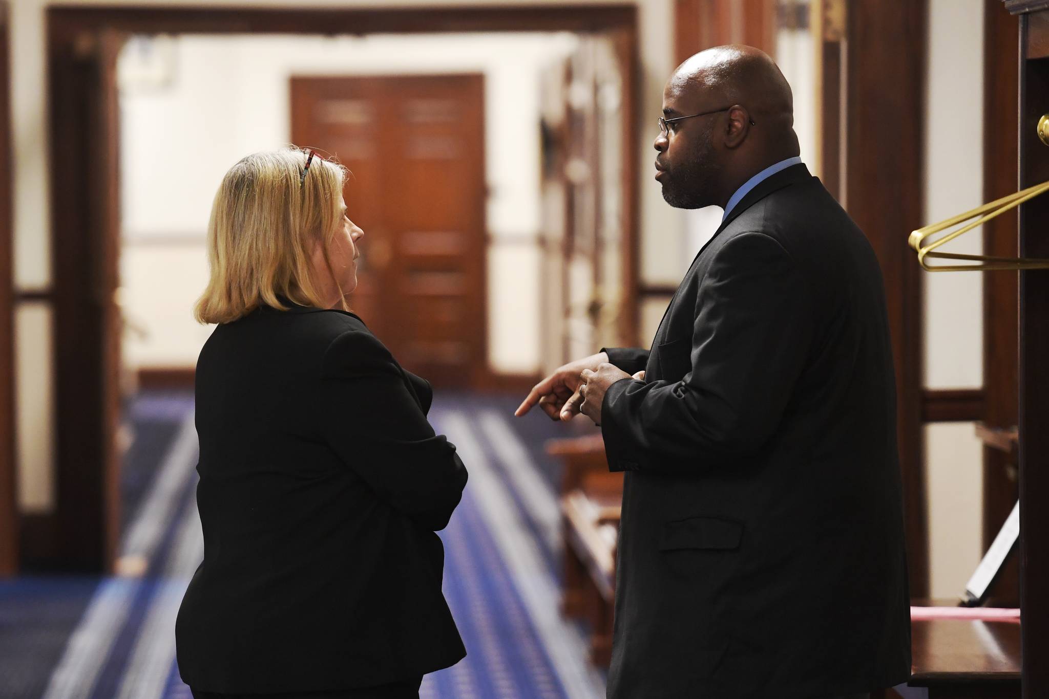 Sen. Tammie Wilson, R-North Pole, left, talks with Sen. David Wilson, R-Wasilla, before a continued Joint Session of the Alaska Legislature at the Capitol on Thursday, July 11, 2019. (Michael Penn | Juneau Empire)