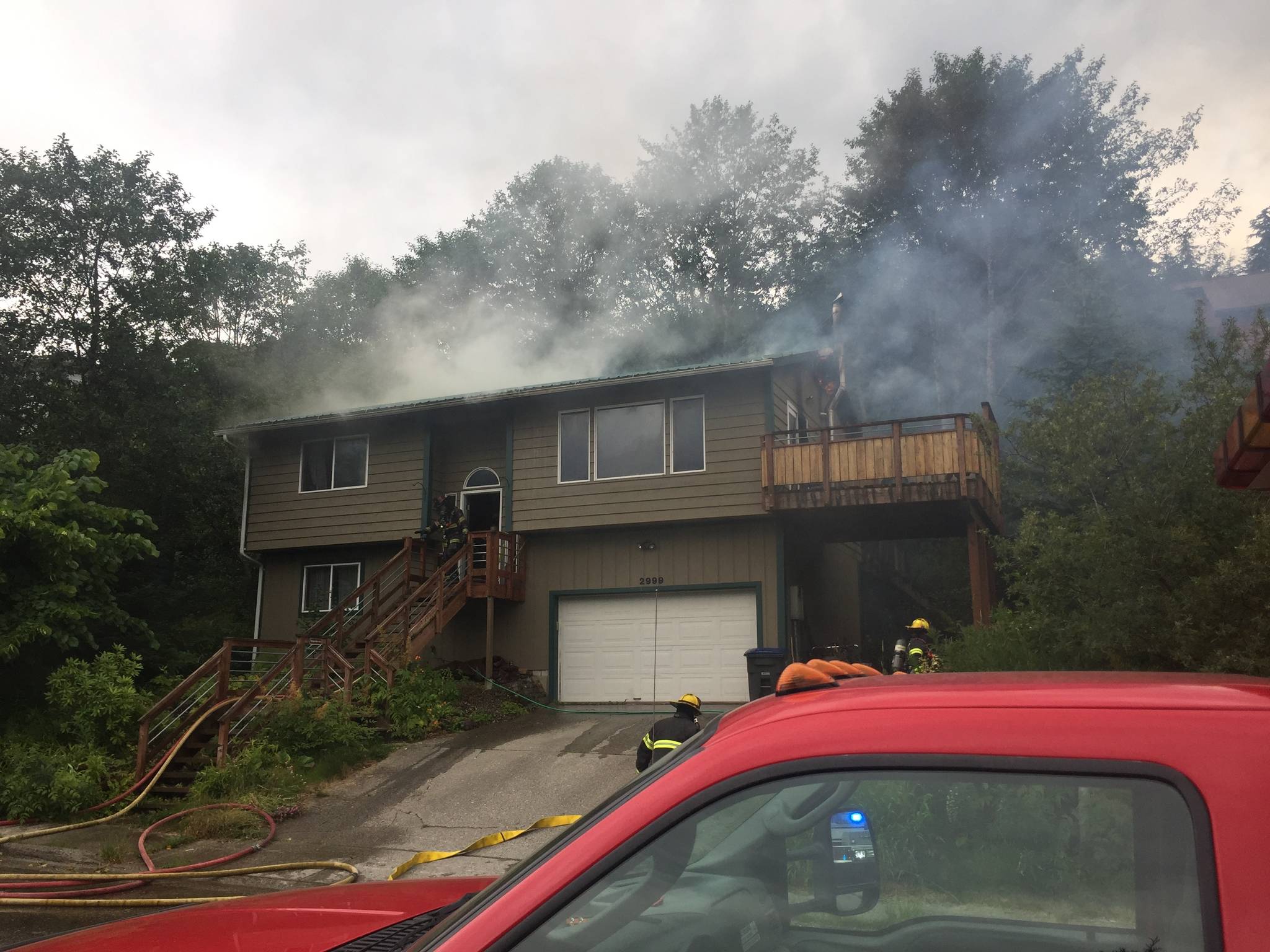 Firefighters are responding to a fire at this house on Douglas Island, Thursday, July 11, 2019. (Nolin Ainsworth | Juneau Empire)