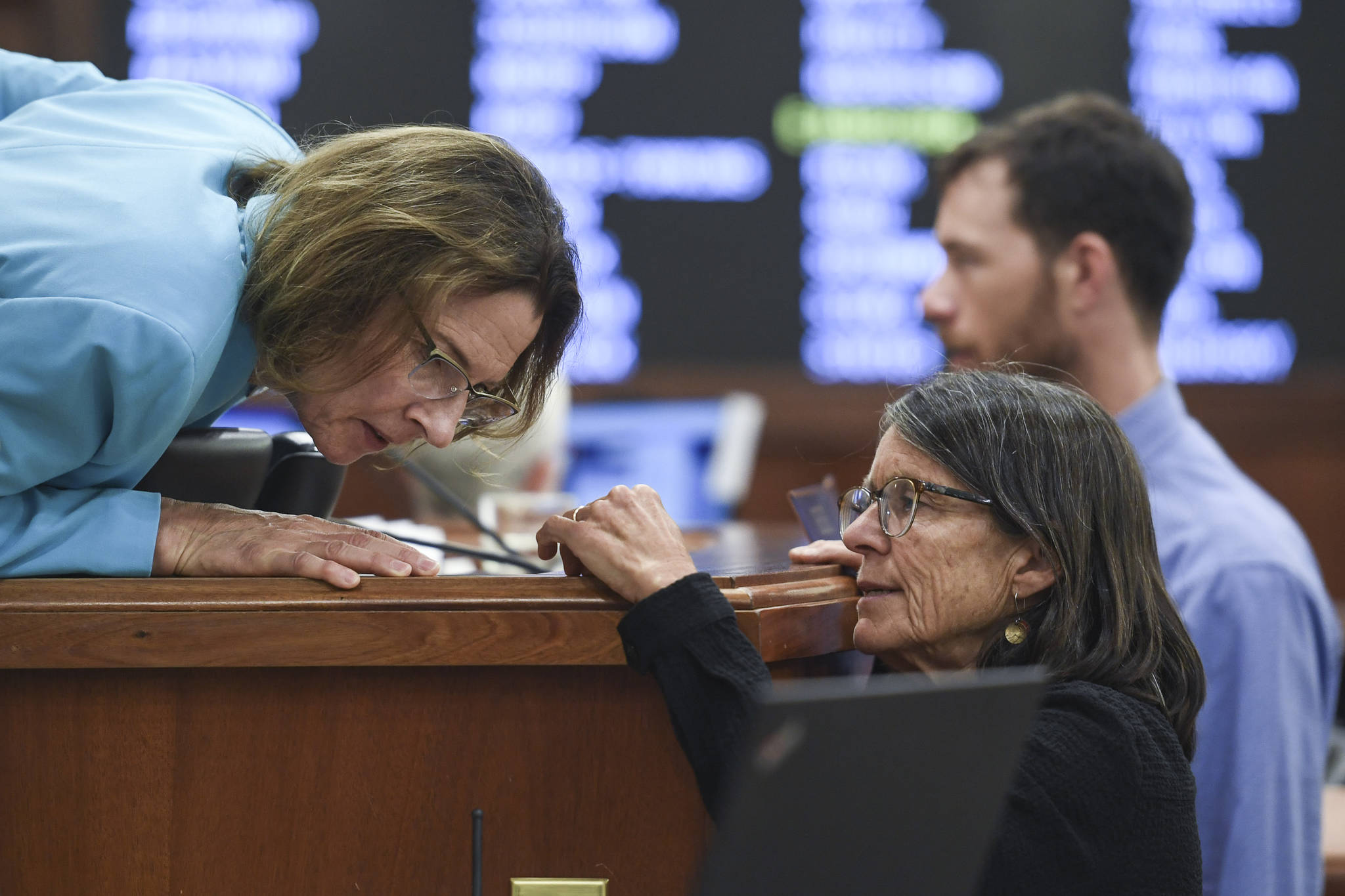 Senate President Cathy Giessel, R-Anchorage, left, leans in to listen to Rep. Jennifer Johnston, R-Anchorage, during a Joint Session of Alaska Legislature at the Capitol on Thursday, July 11, 2019, to debate and vote on an override of Gov. Mike Dunleavy’s budget vetoes. The vote didn’t take place because not enough legislators attended. (Michael Penn | Juneau Empire)