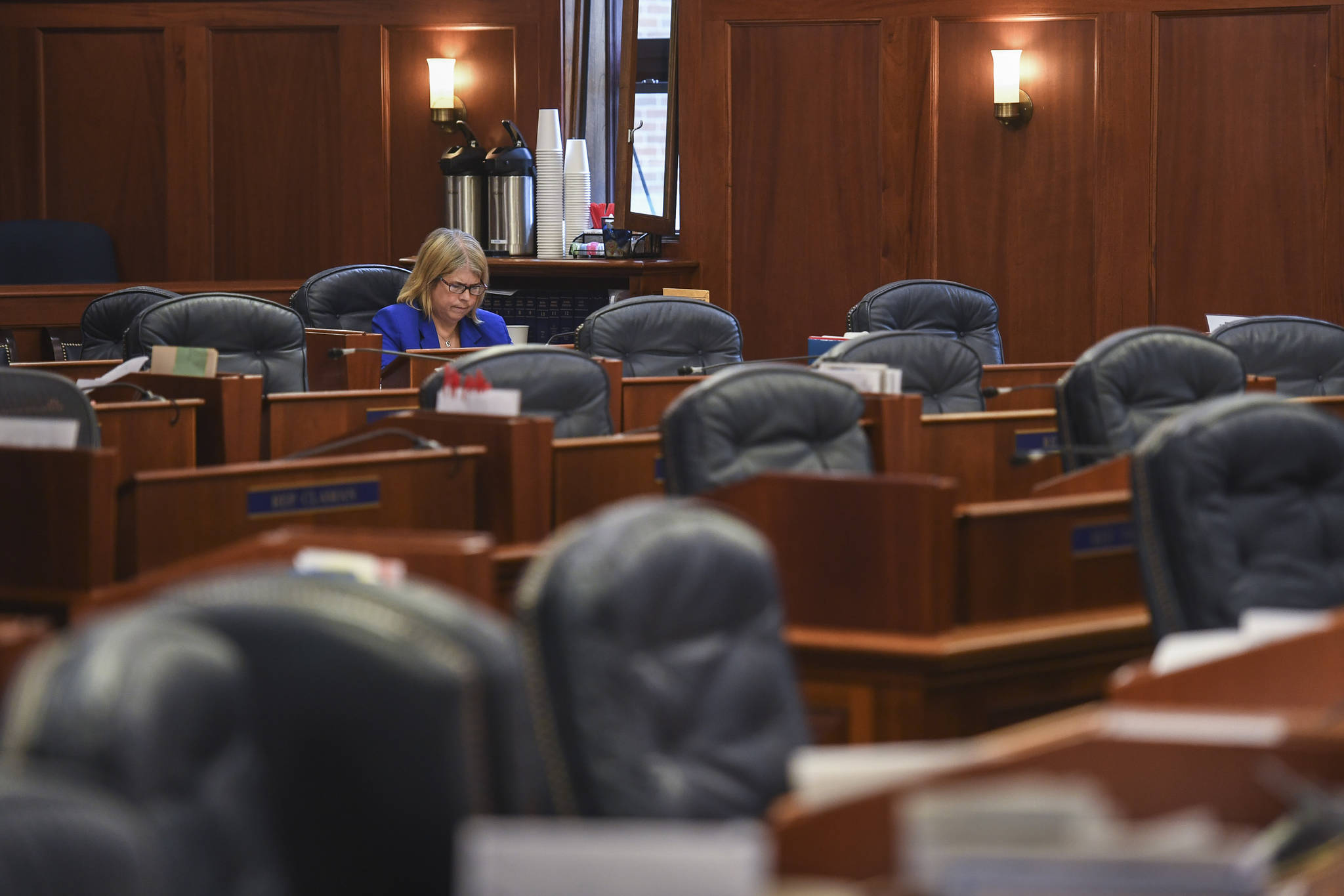 Rep. Tammie Wilson, R-North Pole, sits in the House chambers during a break in the Joint Session of Alaska Legislature on Wednesday, July 10, 2019, at the Capitol to debate and vote on an override of Gov. Mike Dunleavy’s budget vetoes. The vote failed without enough legislators attending. Twenty-two legislators met in Wasilla in support of Dunleavy’s cuts. Wilson voted against the override. (Michael Penn | Juneau Empire)