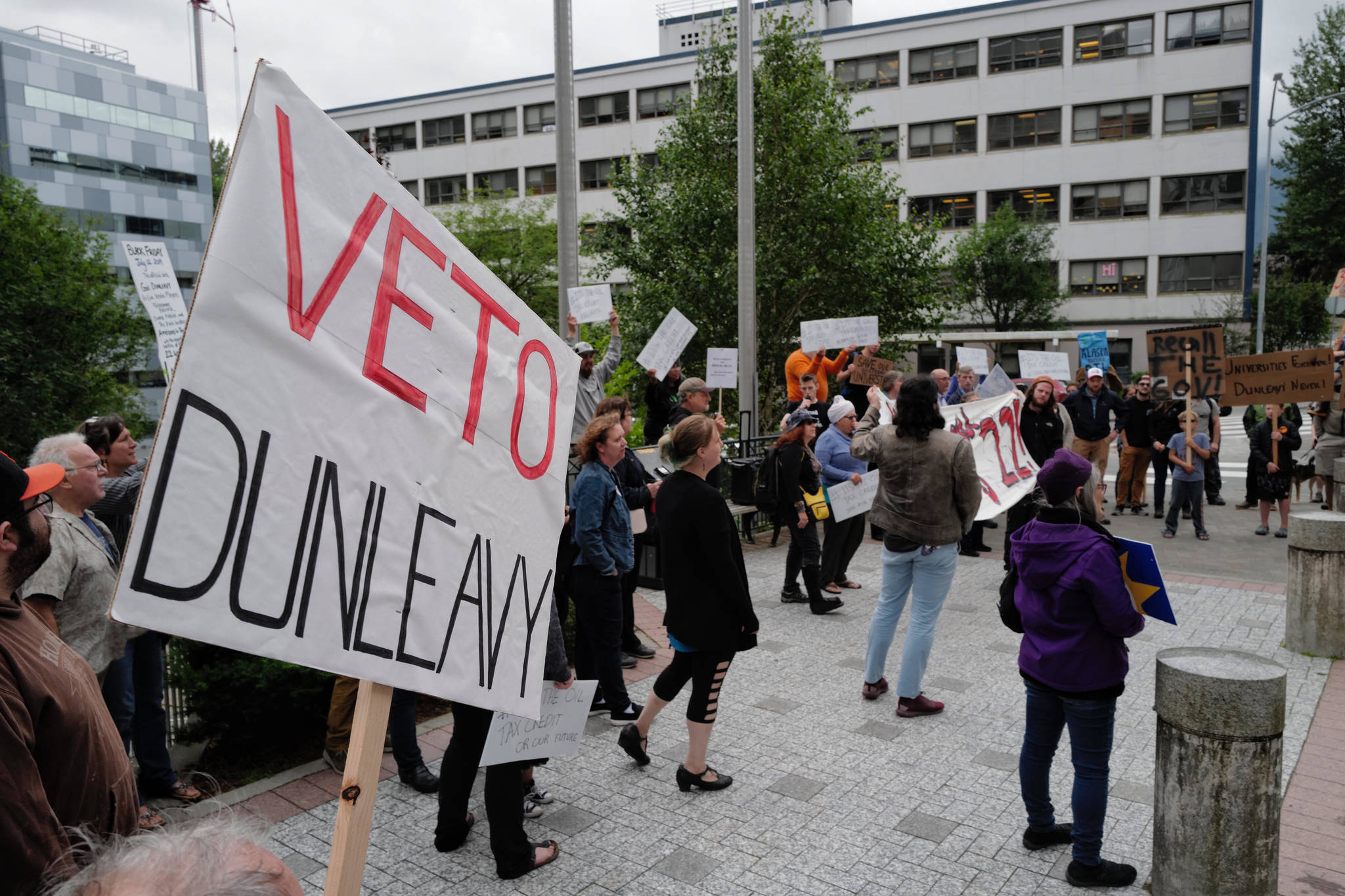 People attend a rally against Gov. Mike Dunleavy’s budget vetoes in front of the Capitol on Friday, July 12, 2019. (Michael Penn | Juneau Empire)